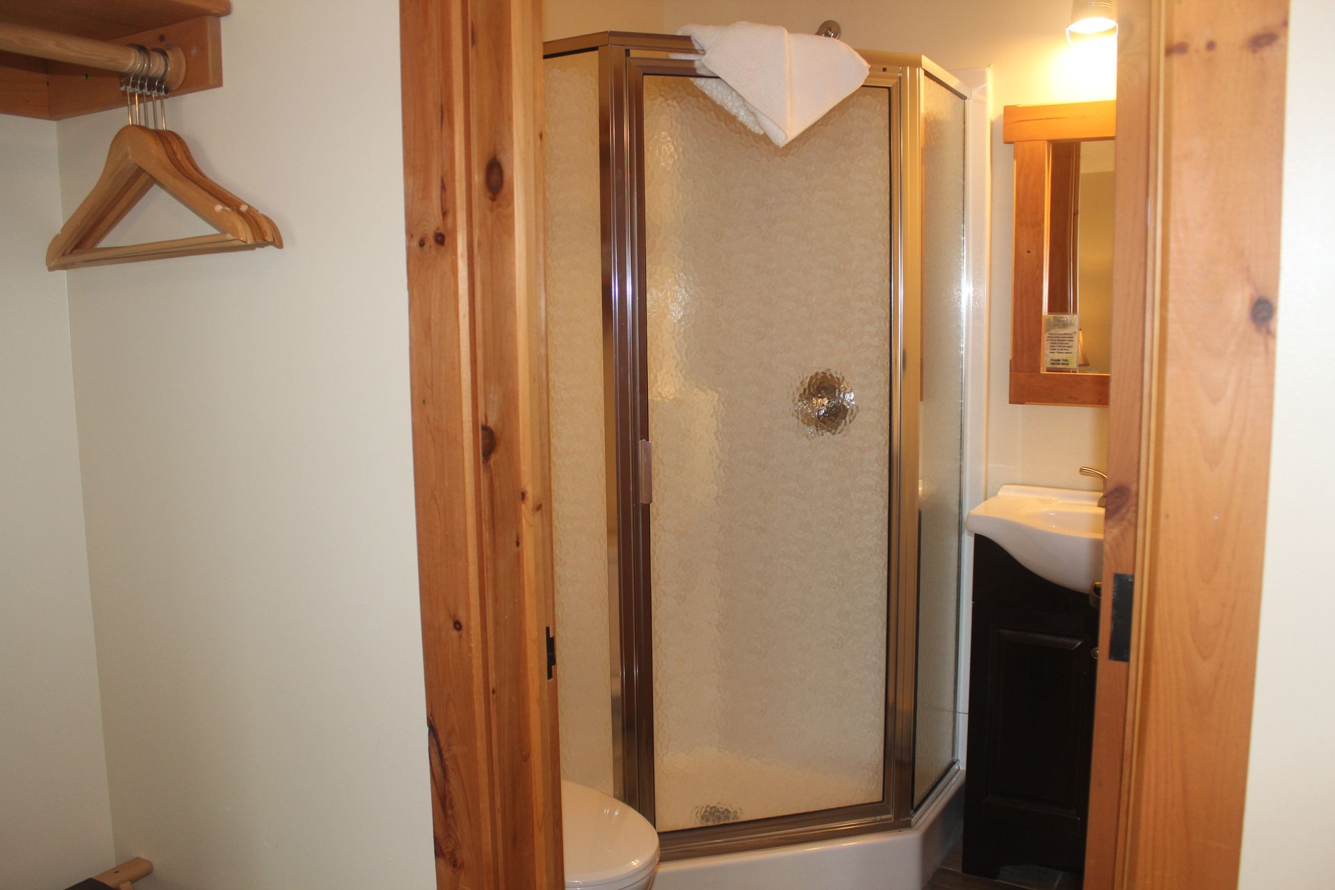 A bathroom with a toilet a sink and a shower