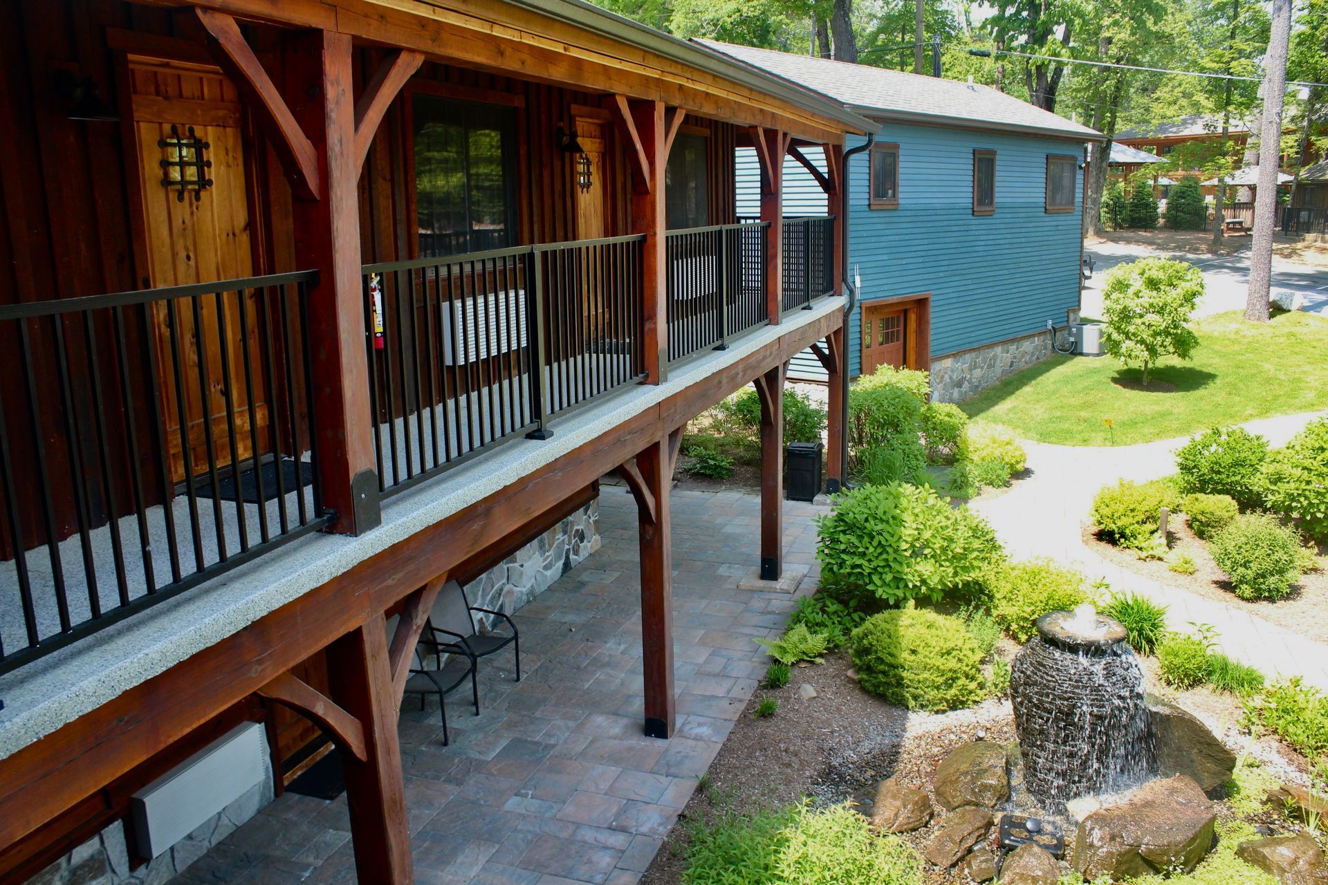 A house with a balcony and a waterfall in the backyard