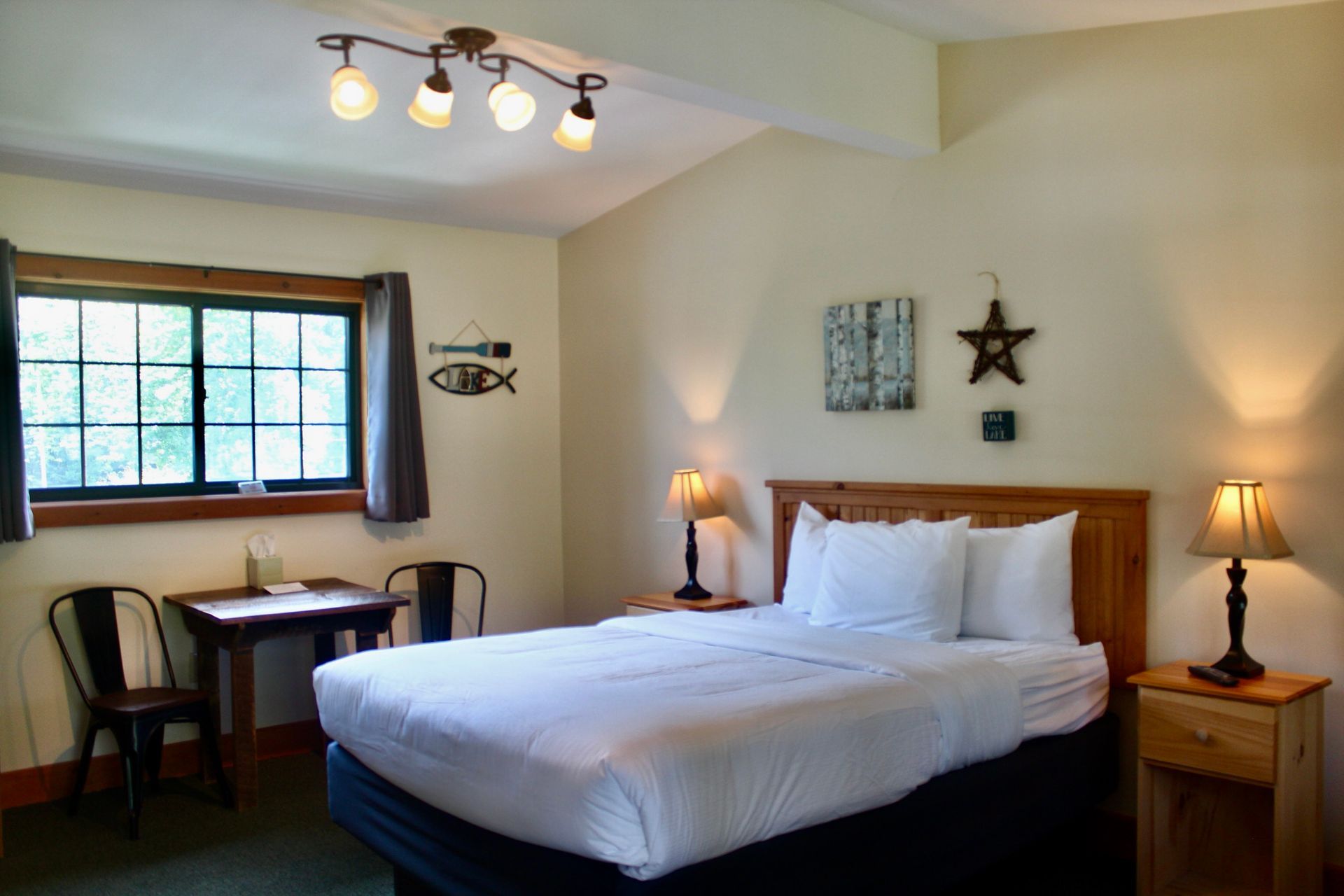 A hotel room with a bed , table and chairs