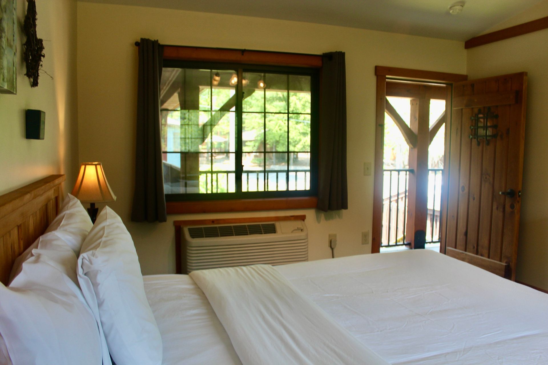 A hotel room with a bed and a window