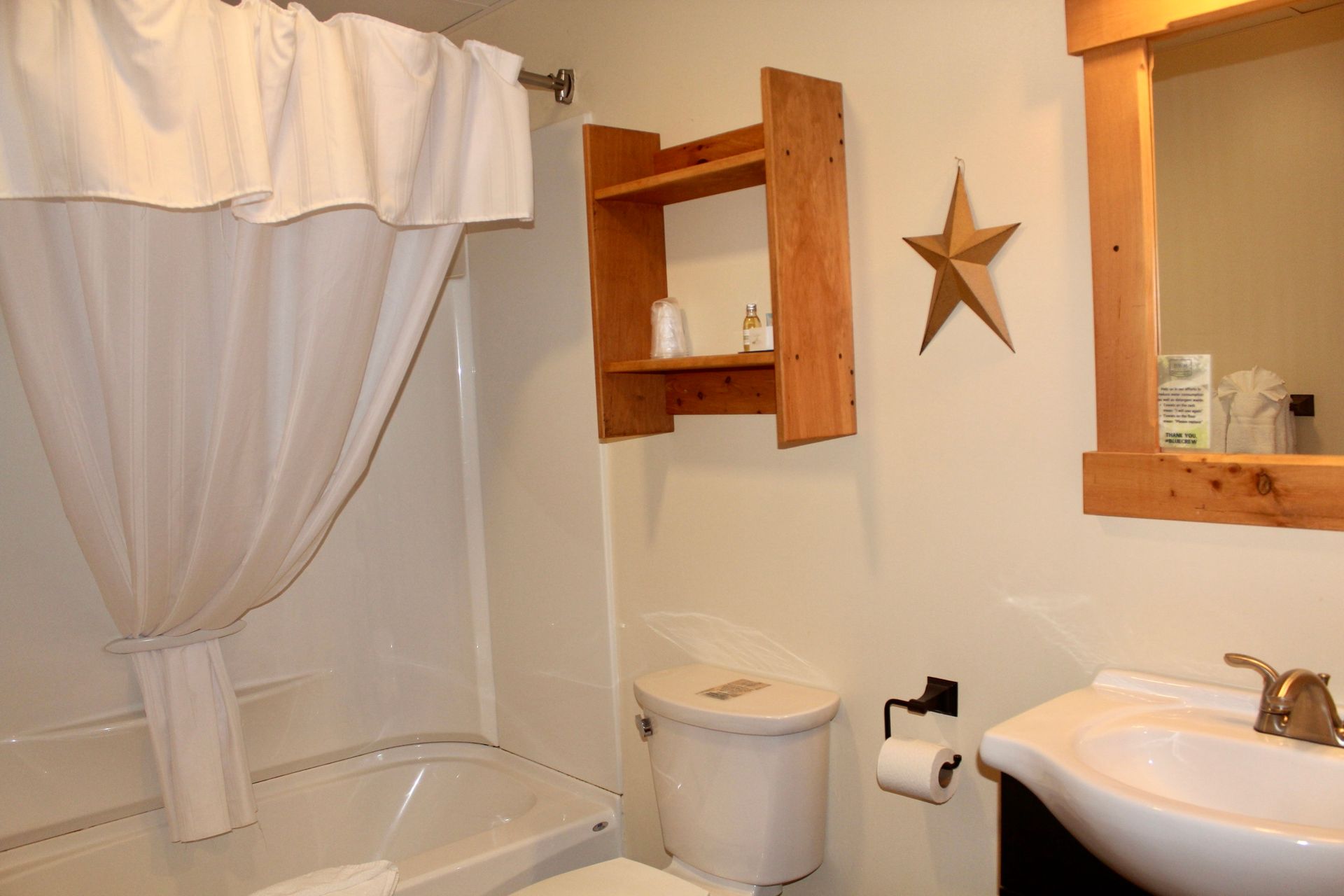 A bathroom with a toilet a sink and a star on the wall