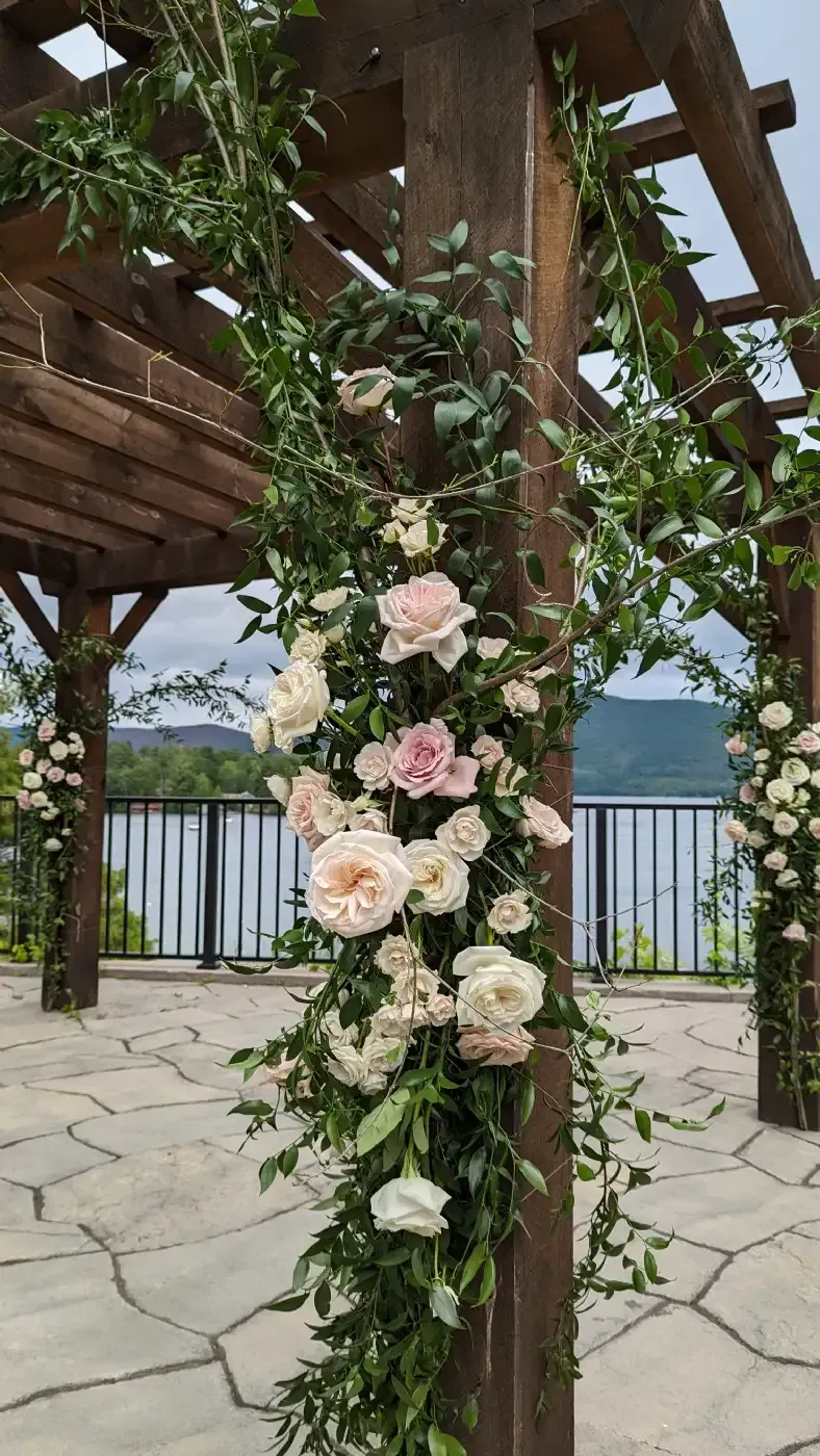 A wooden pergola decorated with flowers and greenery for a wedding ceremony.