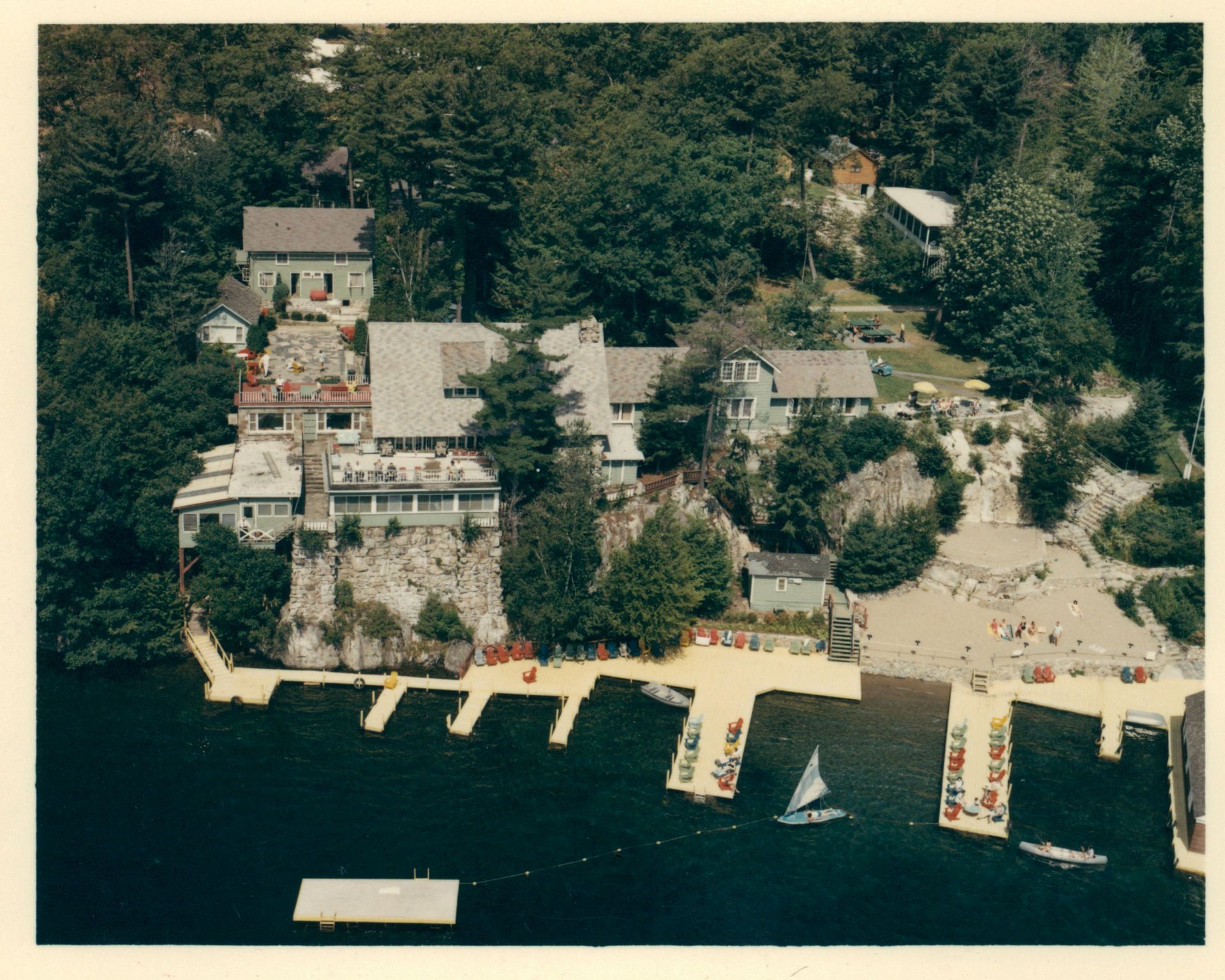 An aerial view of a lake with boats docked