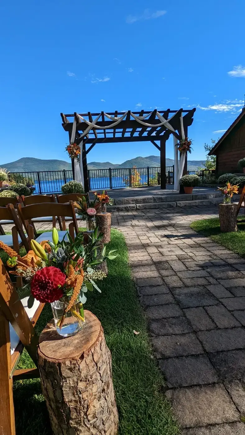 A row of wooden chairs are lined up in front of a wooden archway.