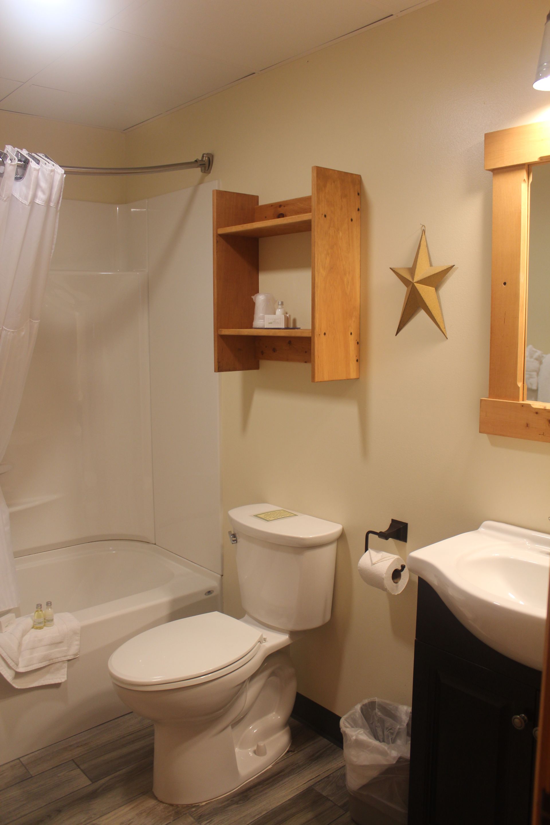 A bathroom with a toilet a sink and a star on the wall