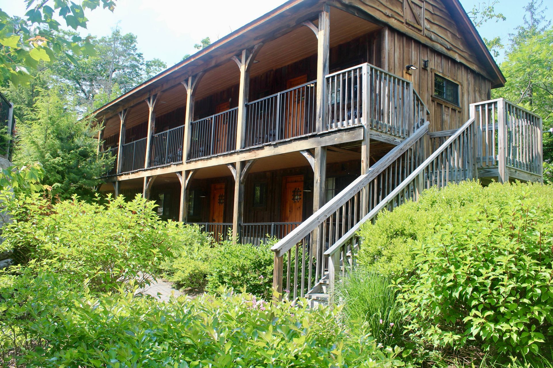 A large wooden house with stairs leading up to it