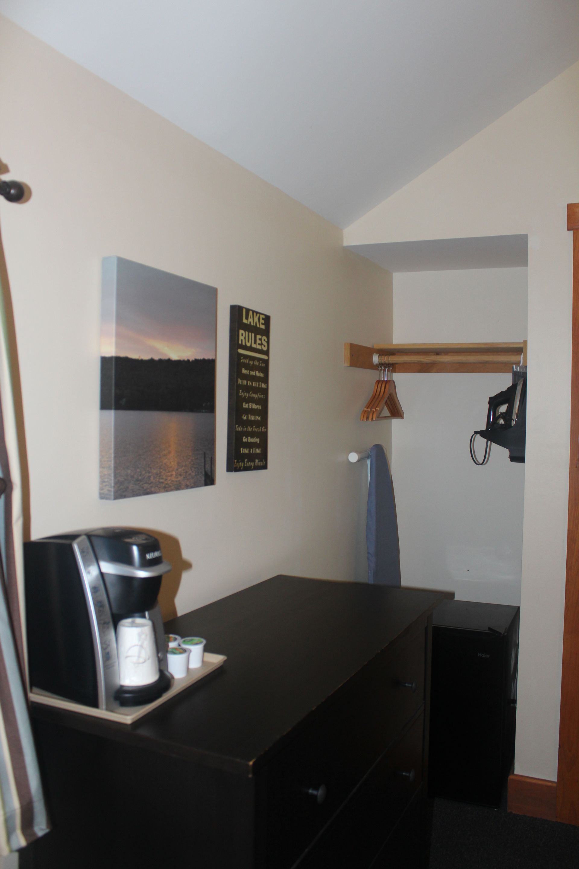 A room with a keurig coffee maker on a table