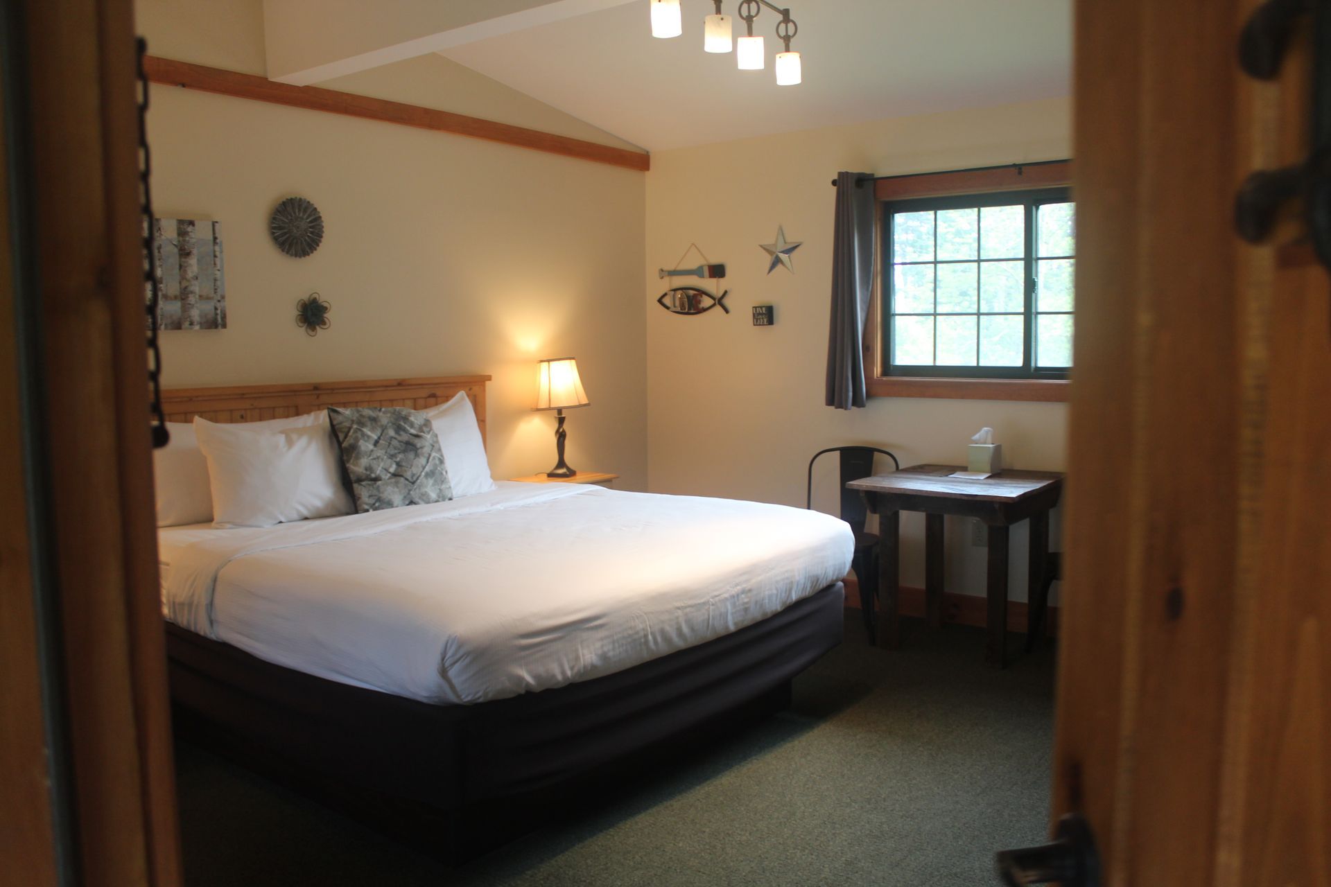 A bedroom with a king size bed and a window