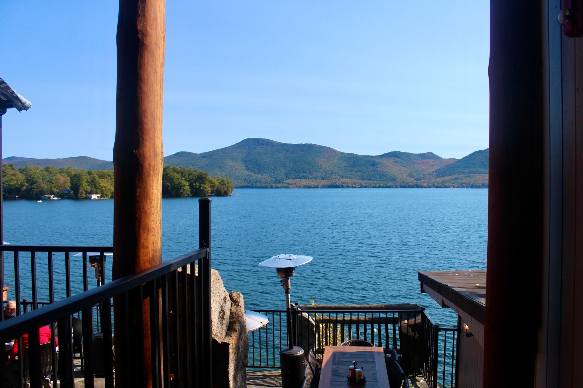 A balcony overlooking a lake with mountains in the background