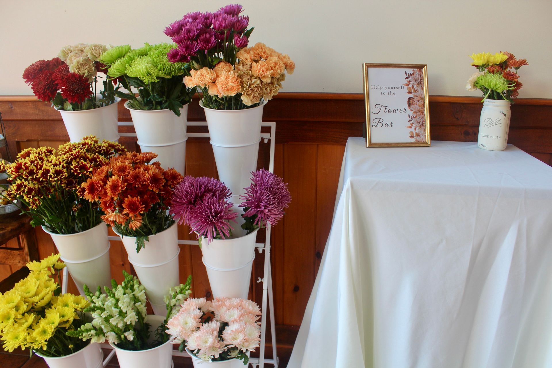 A table with flowers and a sign that says welcome