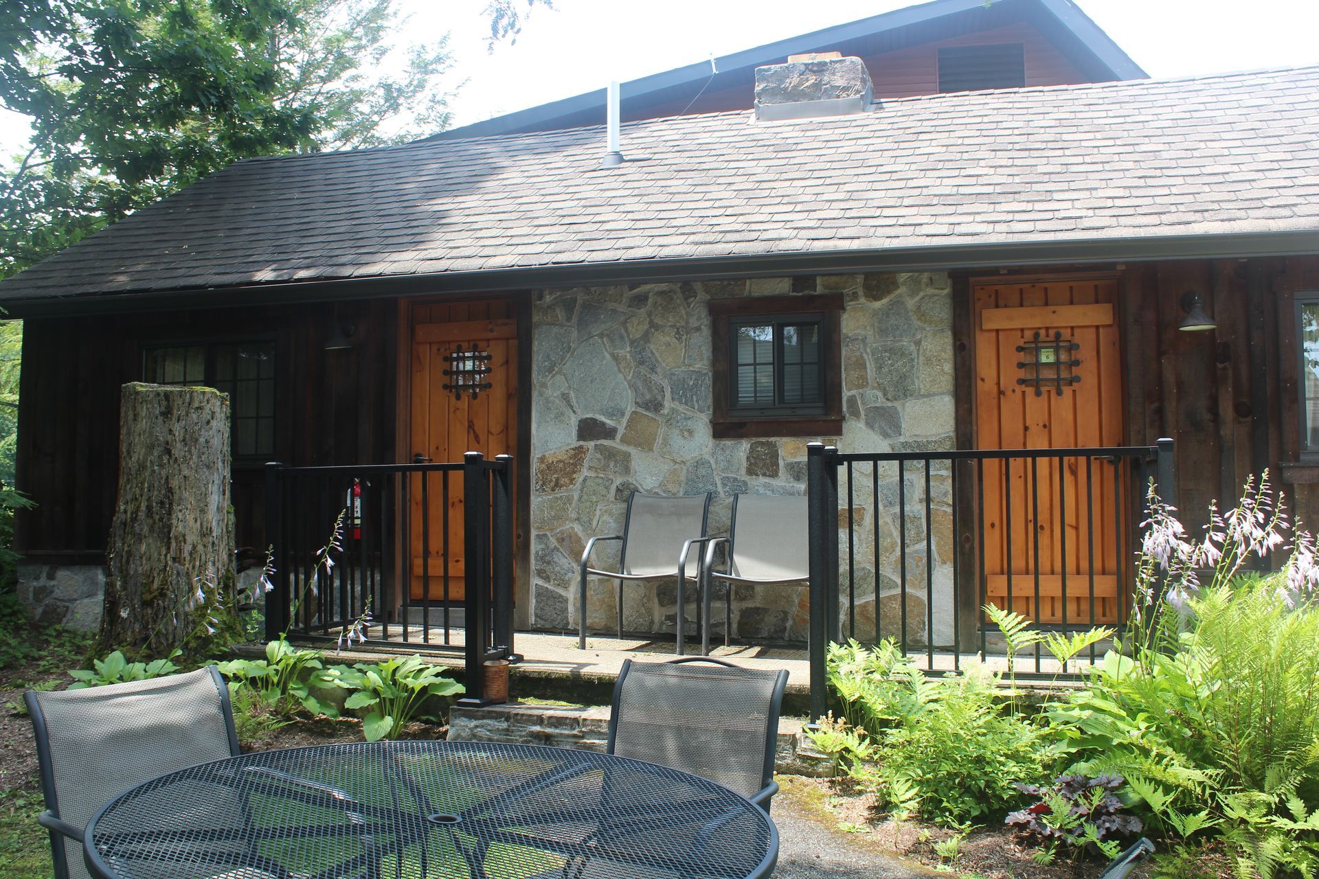 A house with a table and chairs in front of it