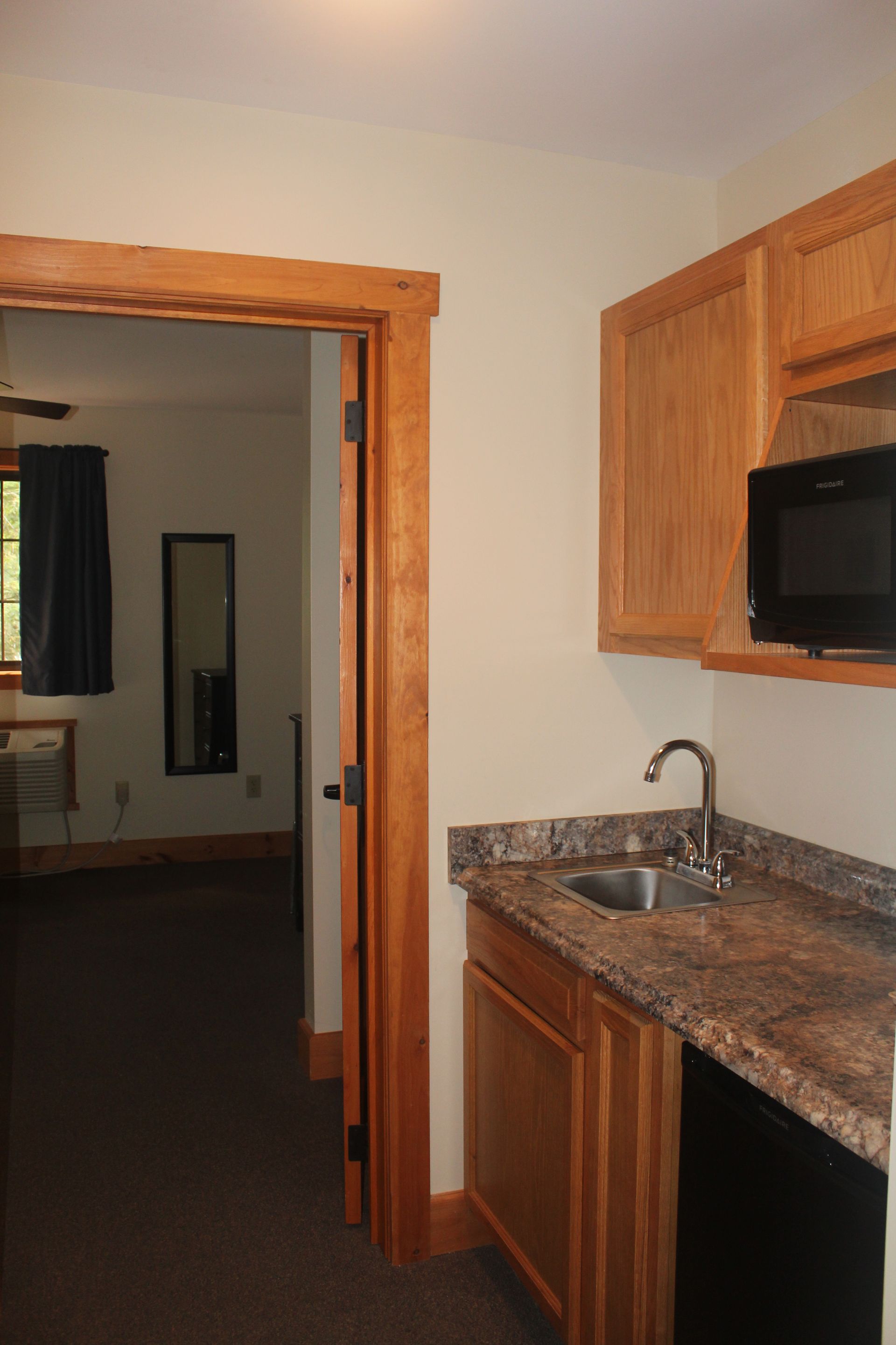A kitchen with a sink , microwave and dishwasher
