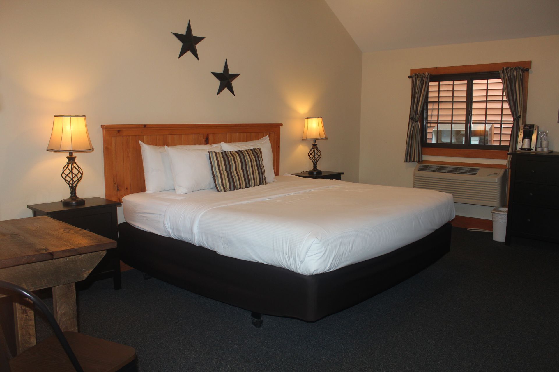 A hotel room with a king size bed and two stars on the wall