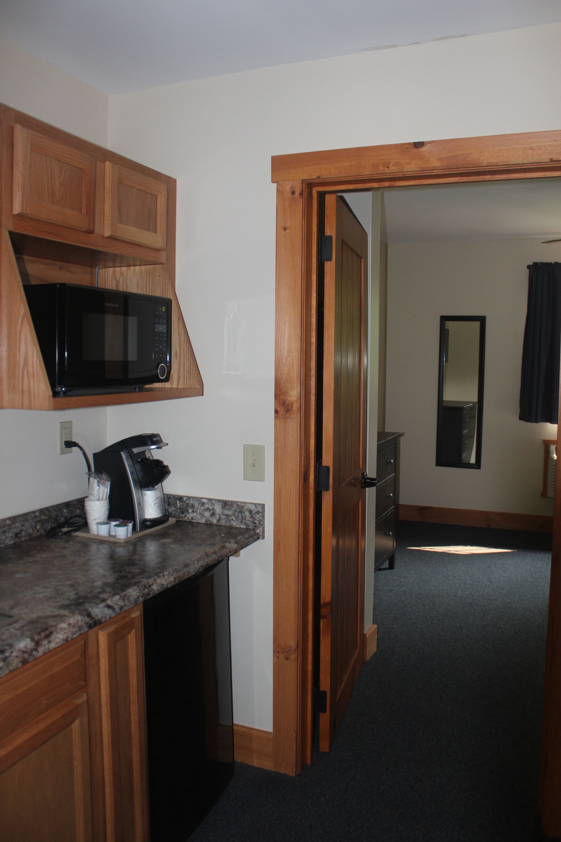 A kitchen with a microwave and a coffee maker