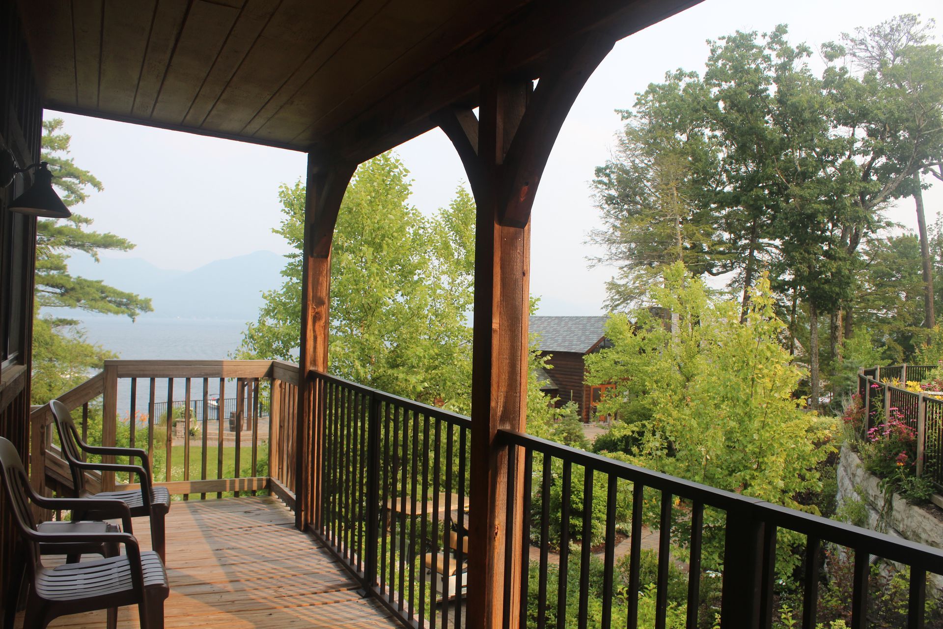 A balcony with a view of trees and mountains