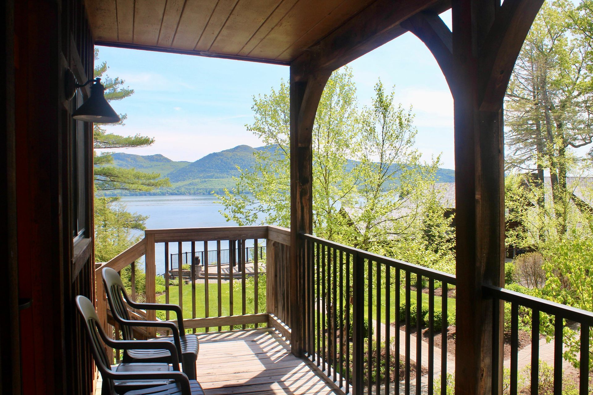 A porch with a view of a lake and mountains