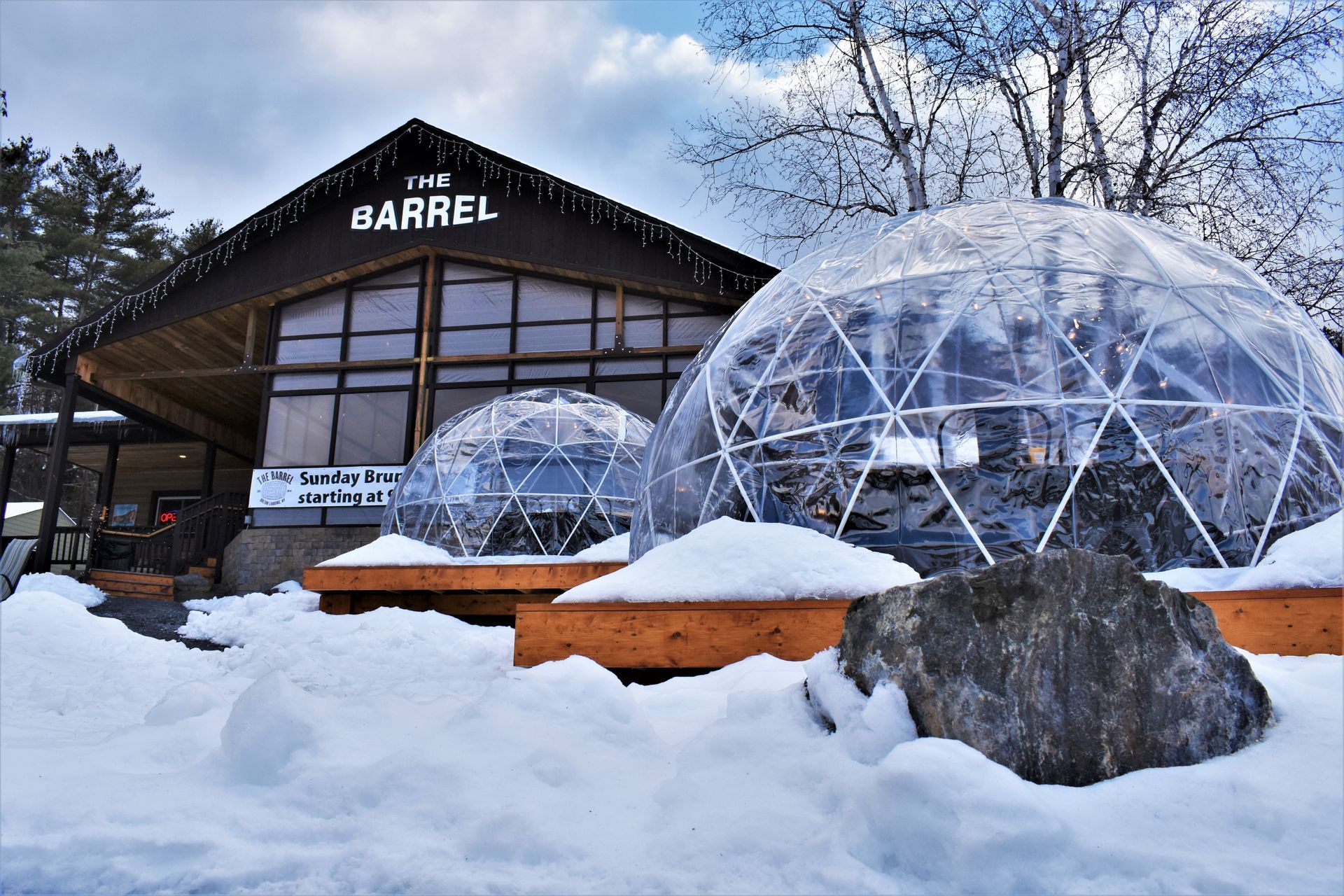 A building with a dome in the snow in front of it.