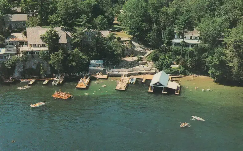 An aerial view of a lake with boats and houses