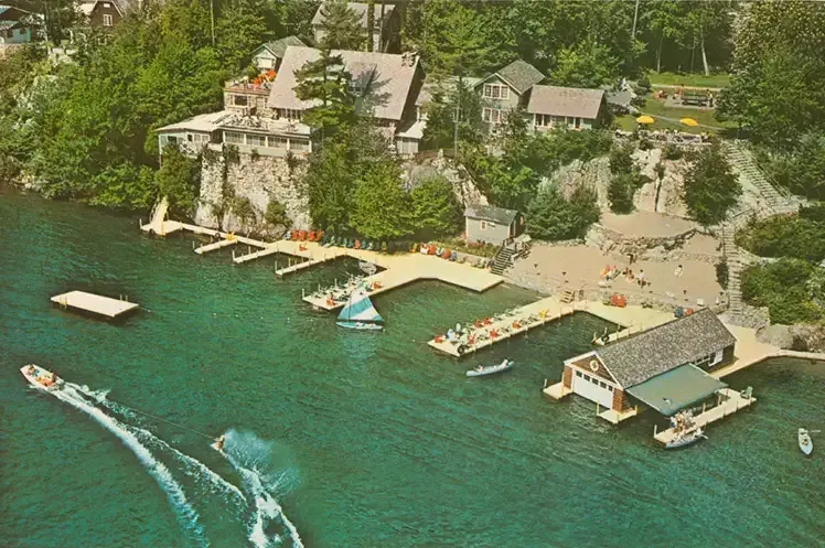 An aerial view of a dock with boats and a house in the background