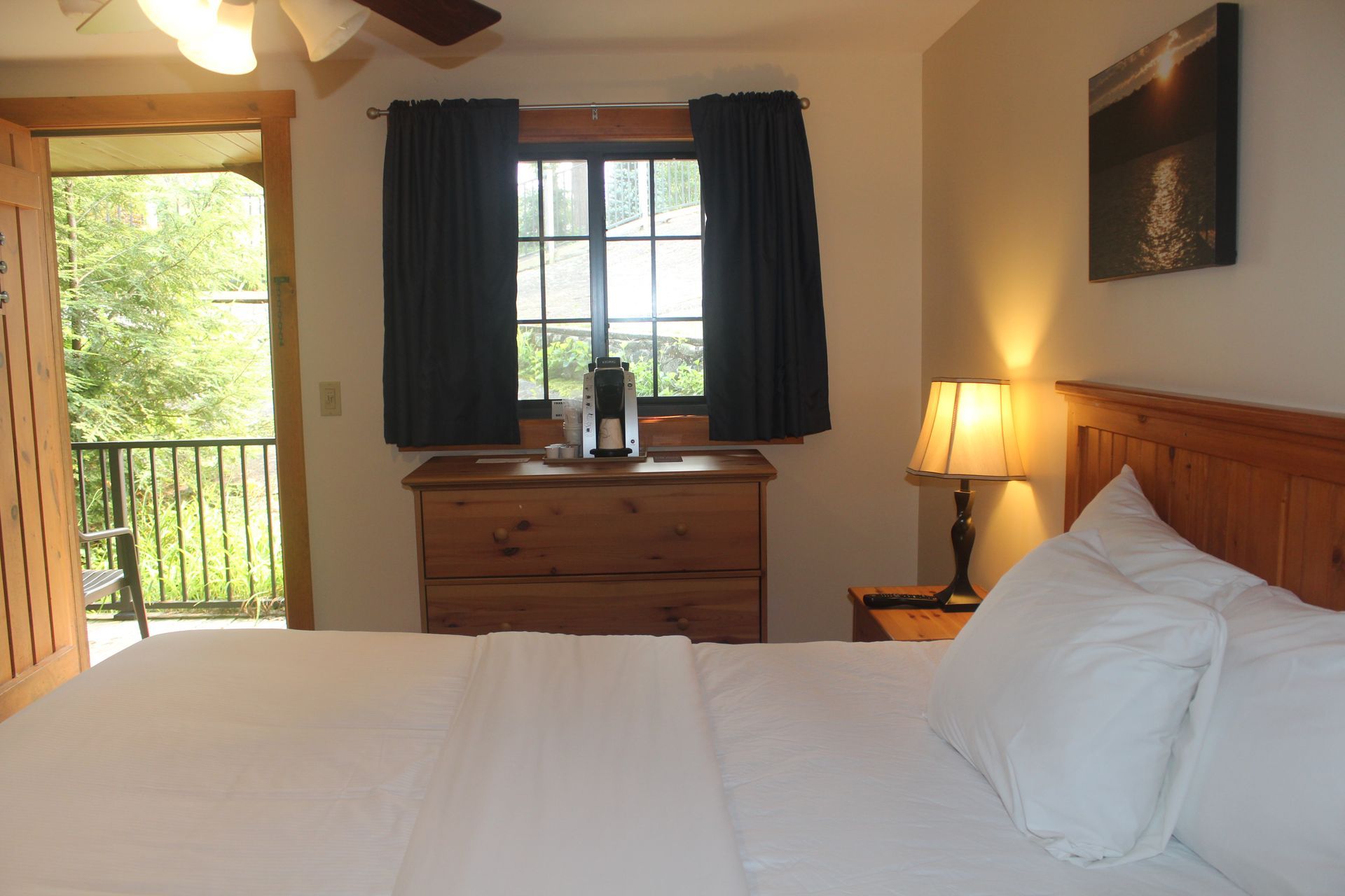 A bedroom with a king size bed and a dresser