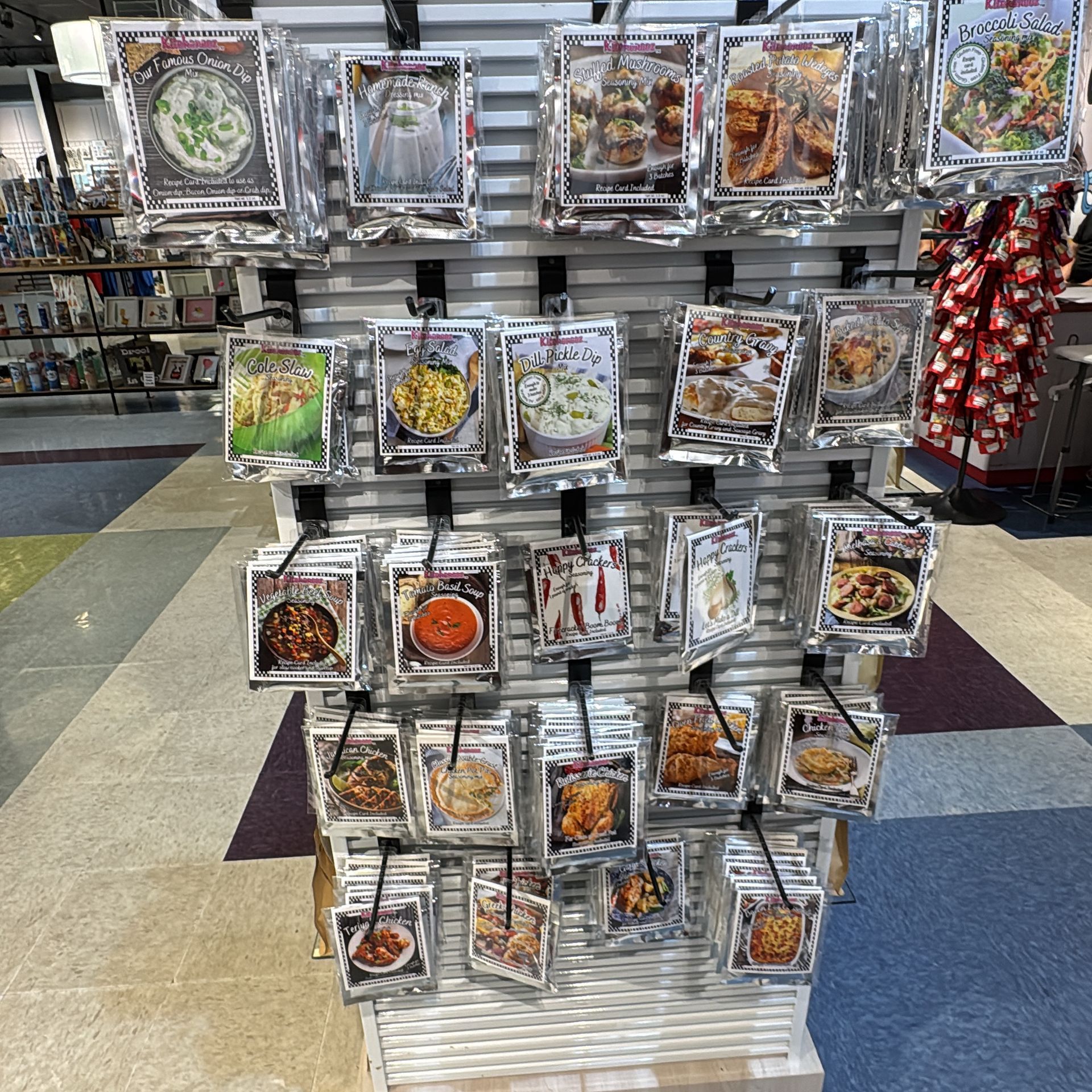 Display of packaged gourmet food products on a store shelf, various recipes and dishes.