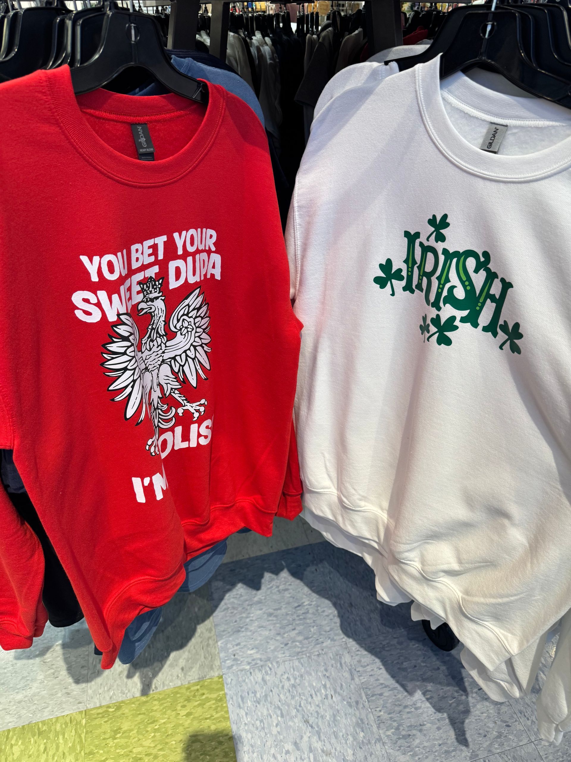 Two sweatshirts: one red with a Polish eagle and text, one white with 