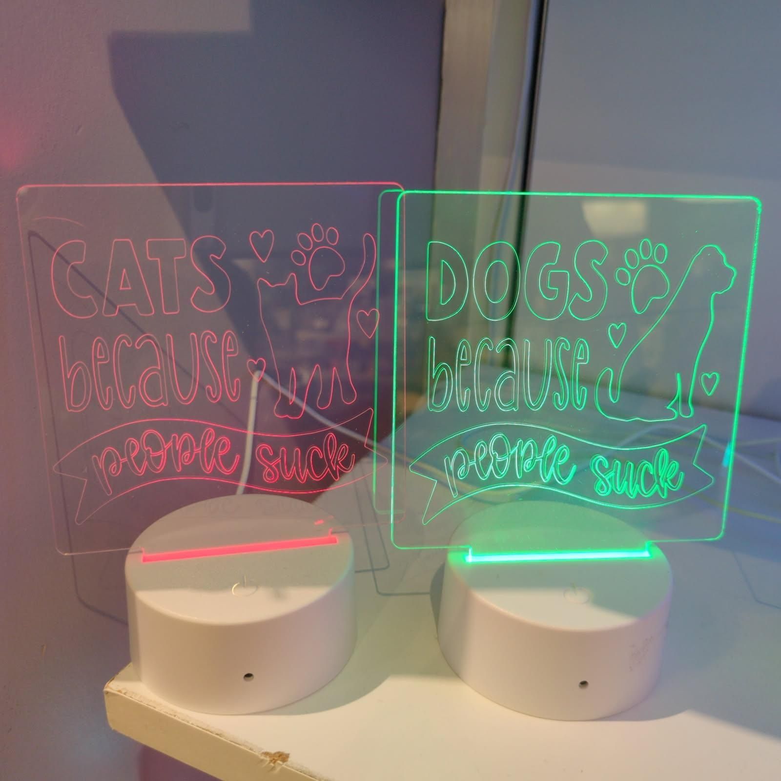 Two illuminated signs, one saying 