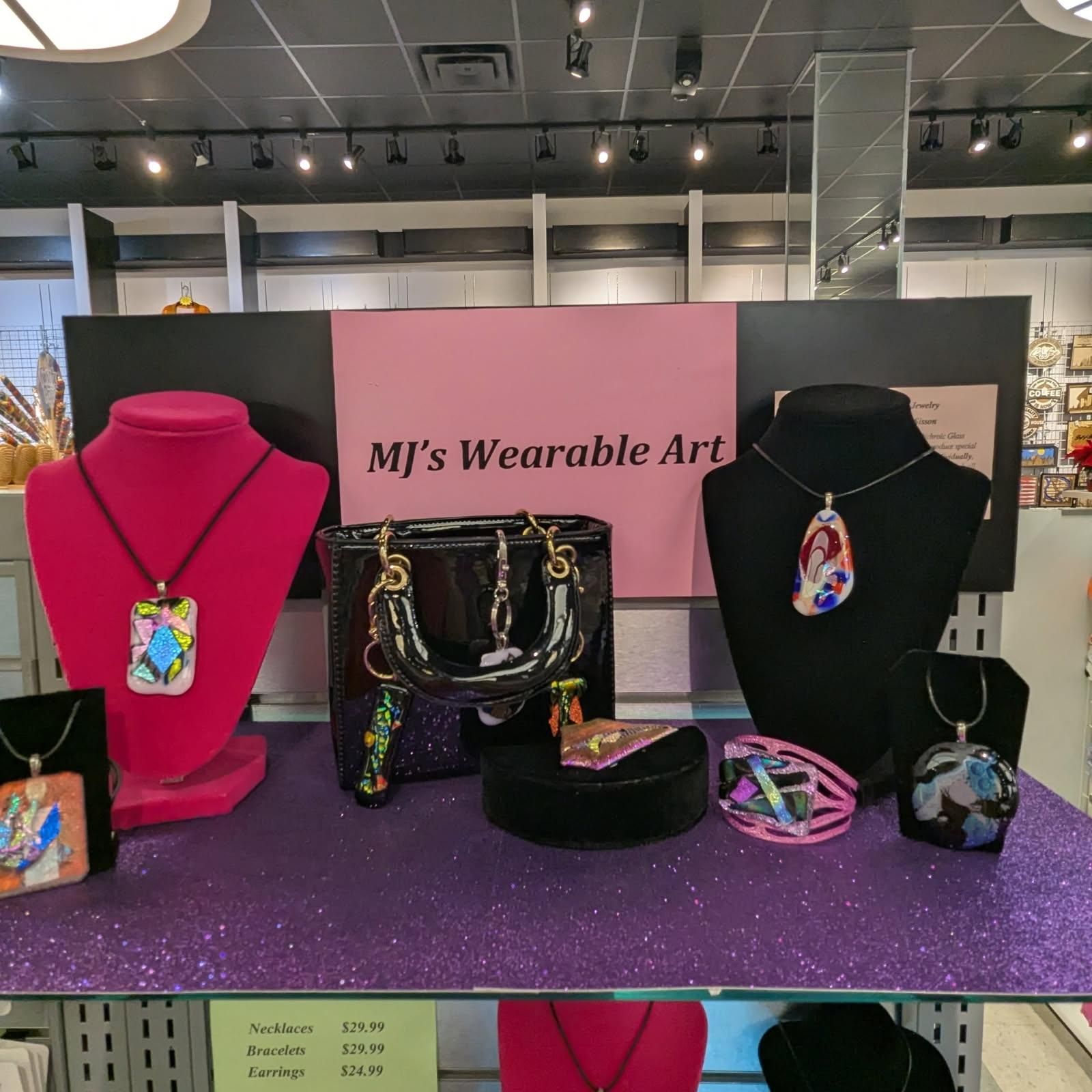 Jewelry display: necklaces, bracelet, and purse; pink, black, and purple, 