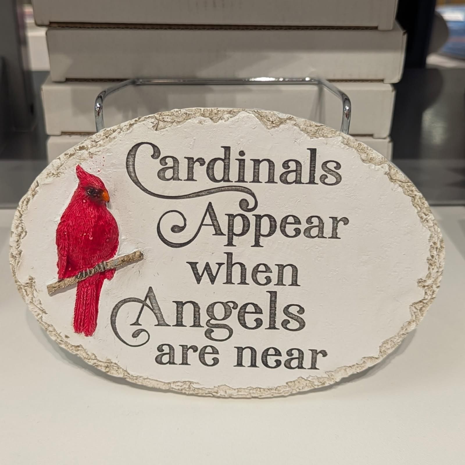 Cream-colored oval sign with the words 