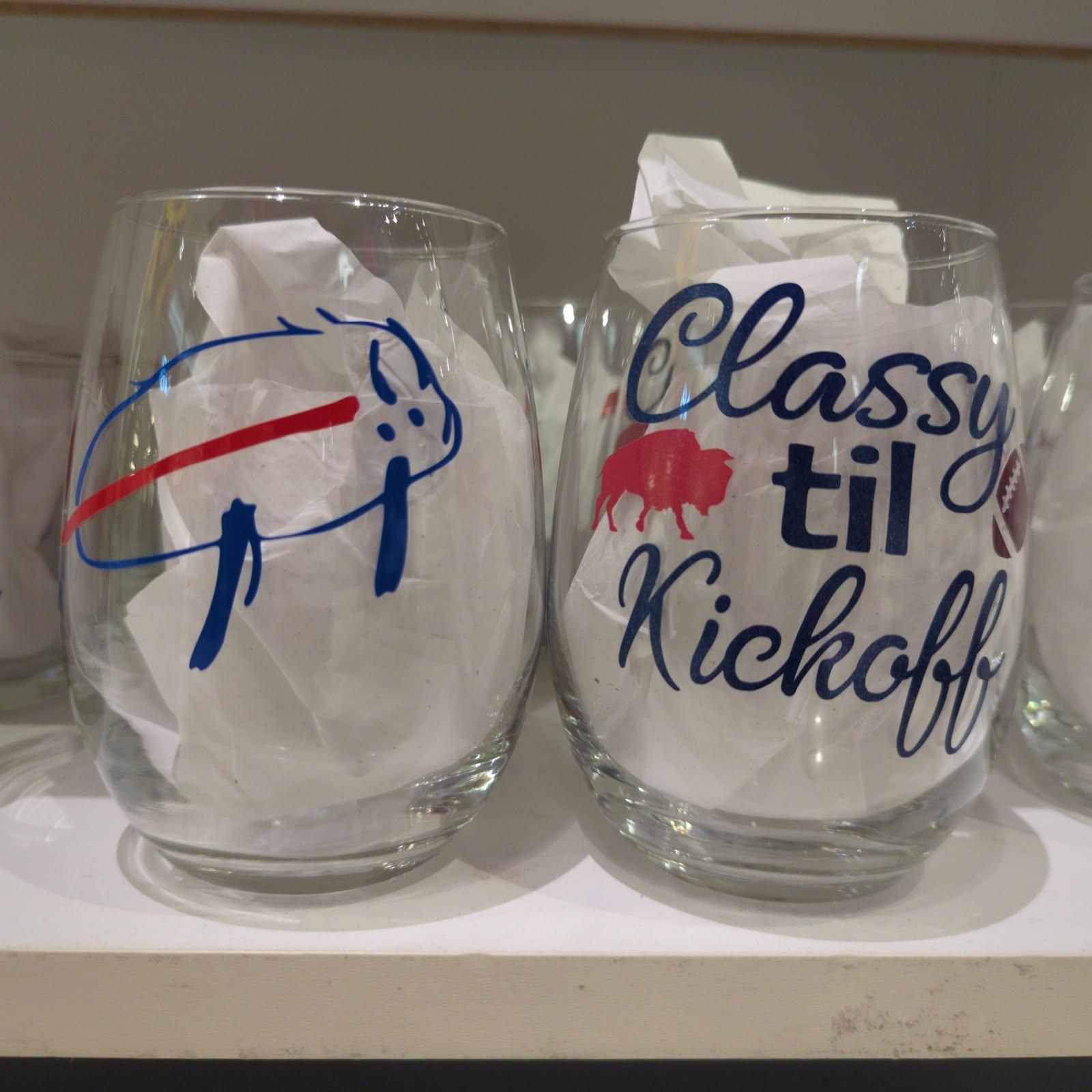 Two stemless wine glasses, one with a Buffalo Bills logo, one with 
