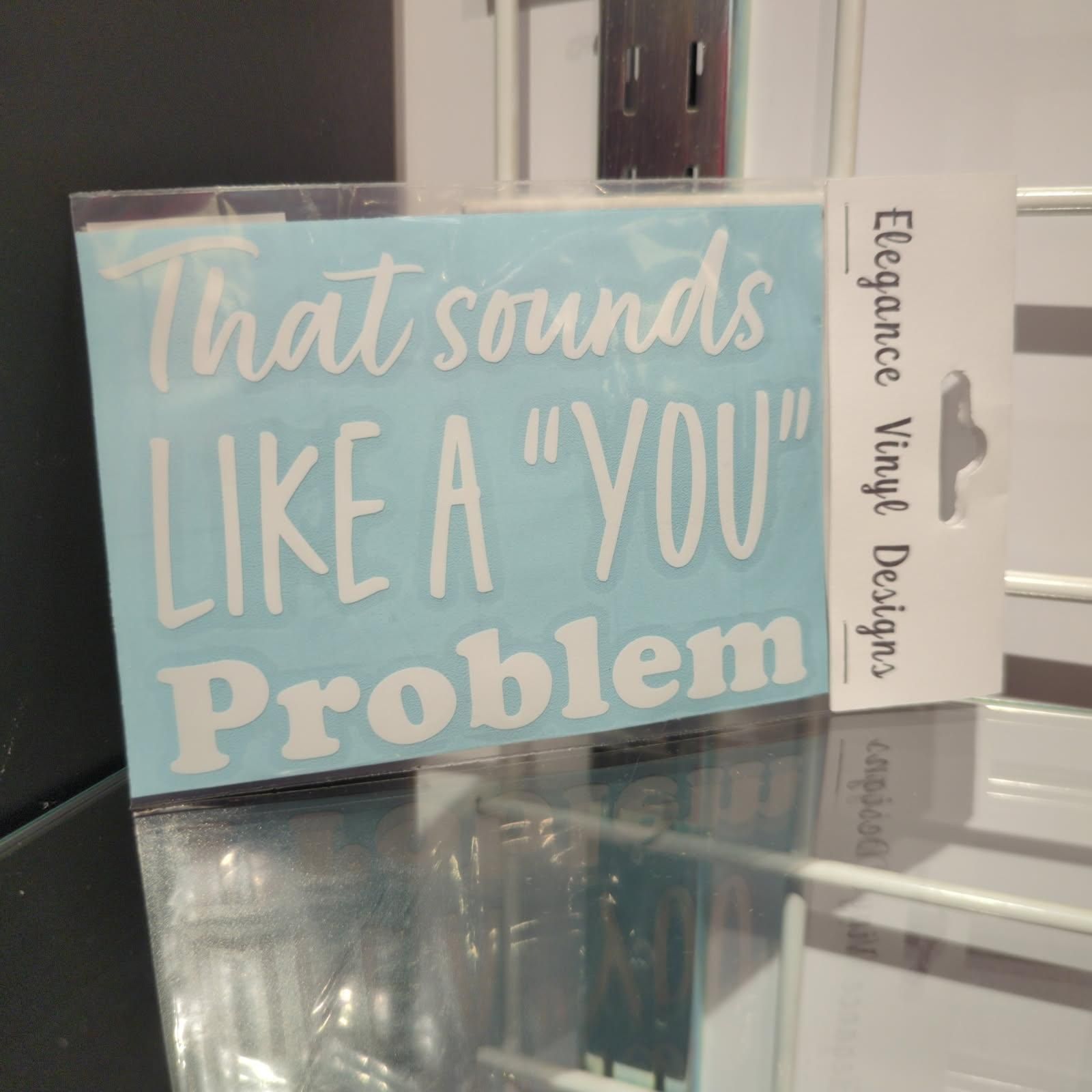 A sticker with white text on a light blue background. Text reads 