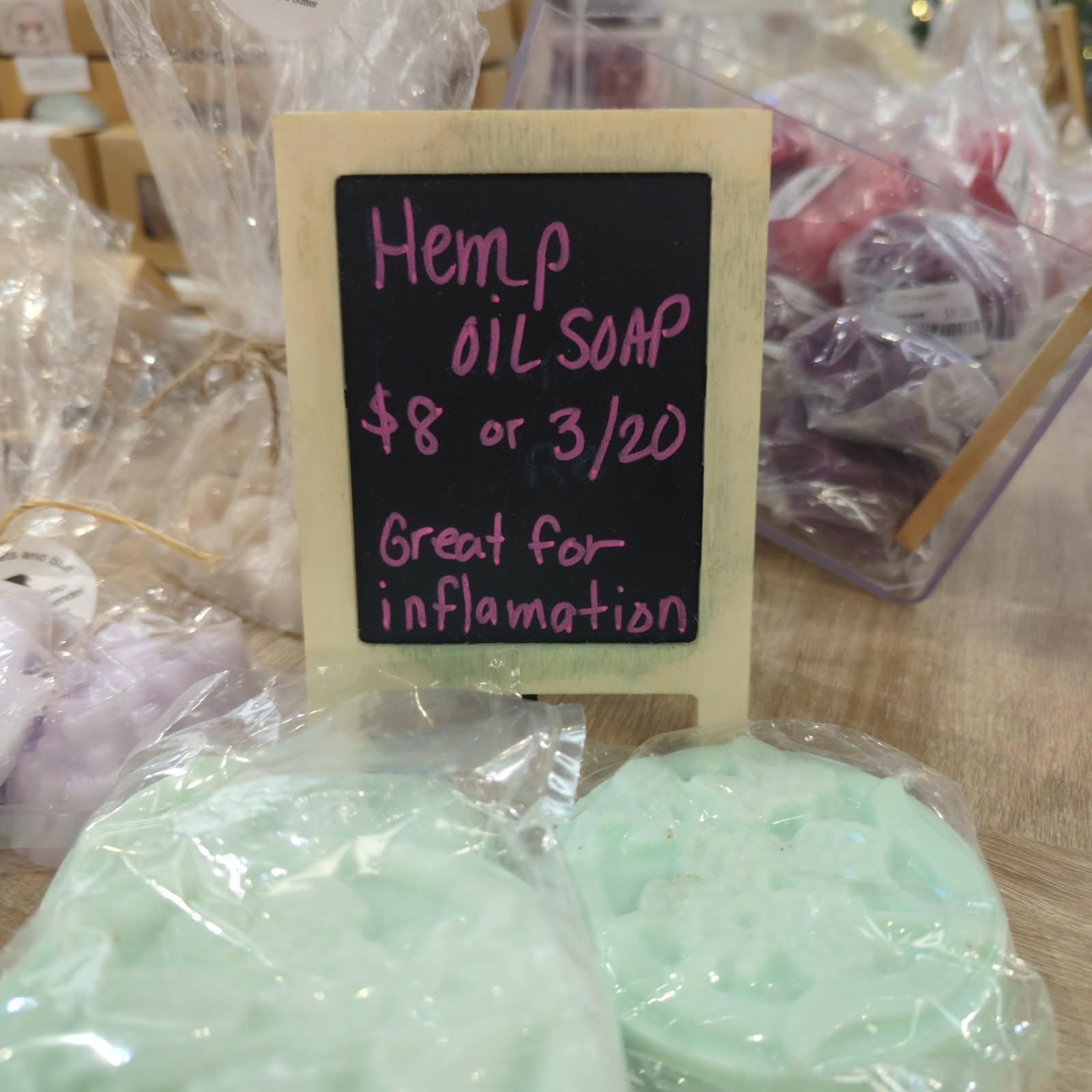 Sign for hemp oil soap: $8 or 3/$20. Great for inflammation. Soap bars in clear packaging.