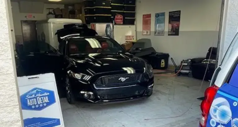 Black mustang being detailed in shop in Chandler, AZ