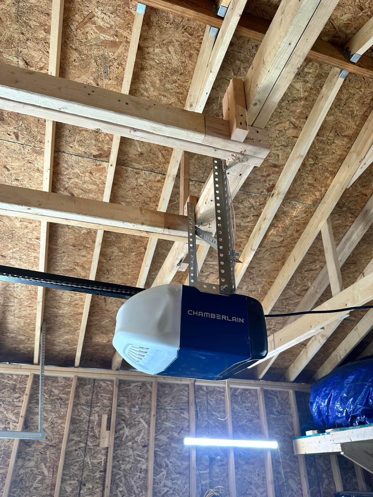 Garage door opener mounted on a wooden ceiling.