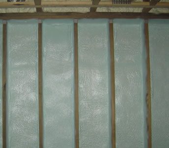 an empty attic with wooden beams and a window .