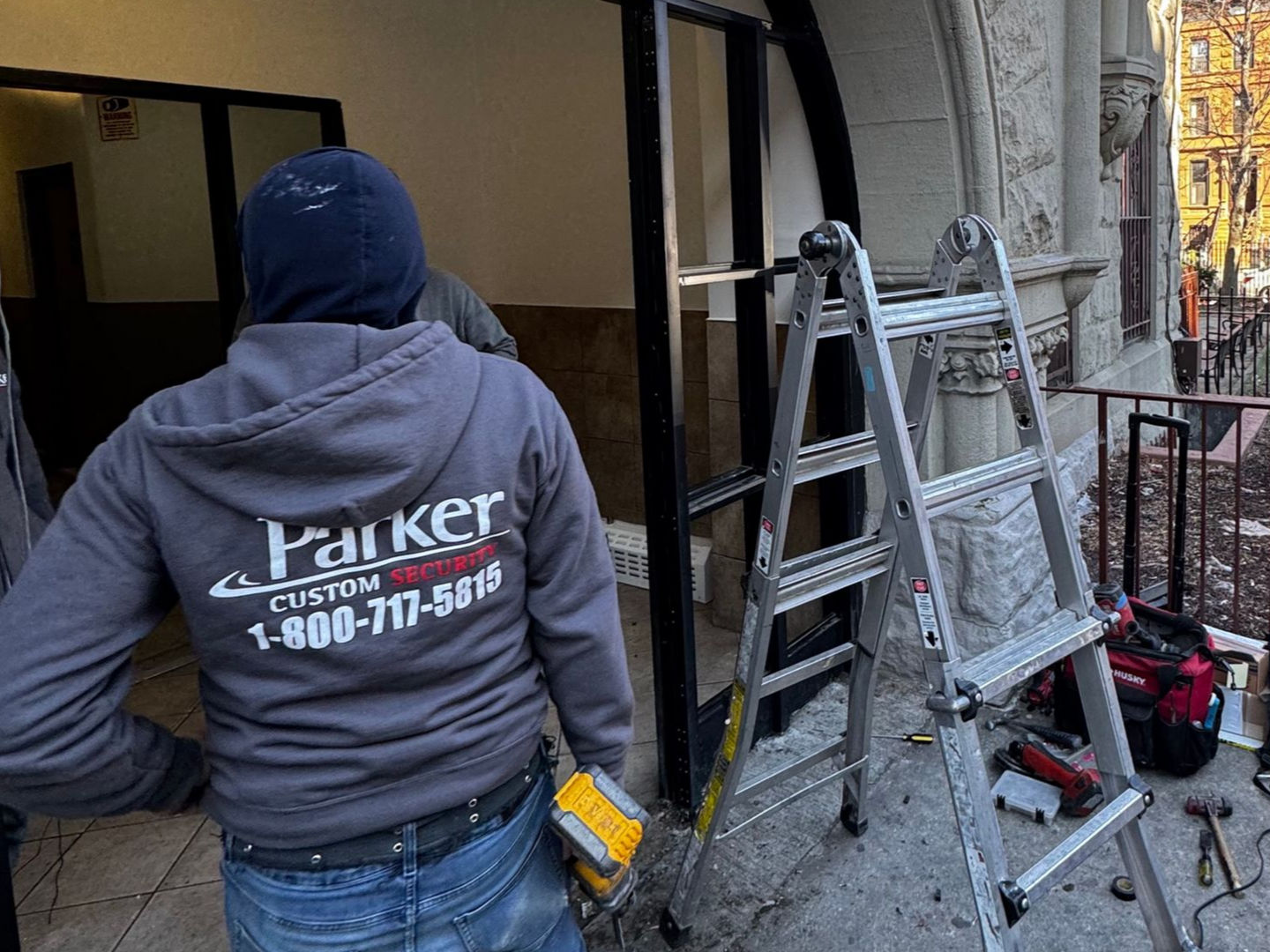 Installing storefront apartment doors at a building in Brooklyn