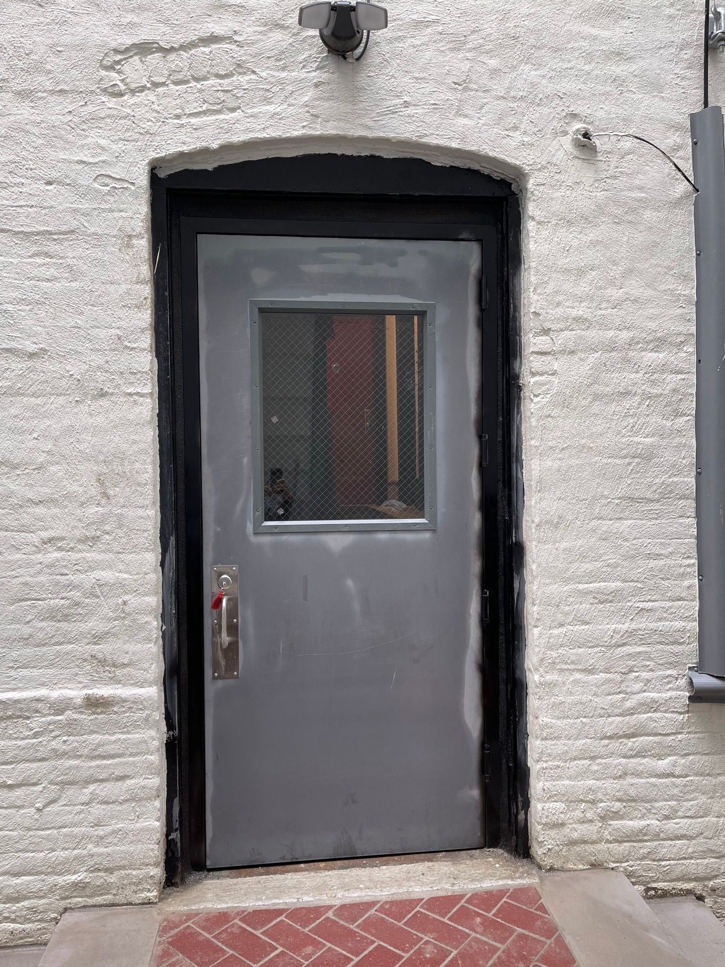 Installed metal security door at an apartment building in Long Island City, Queens 