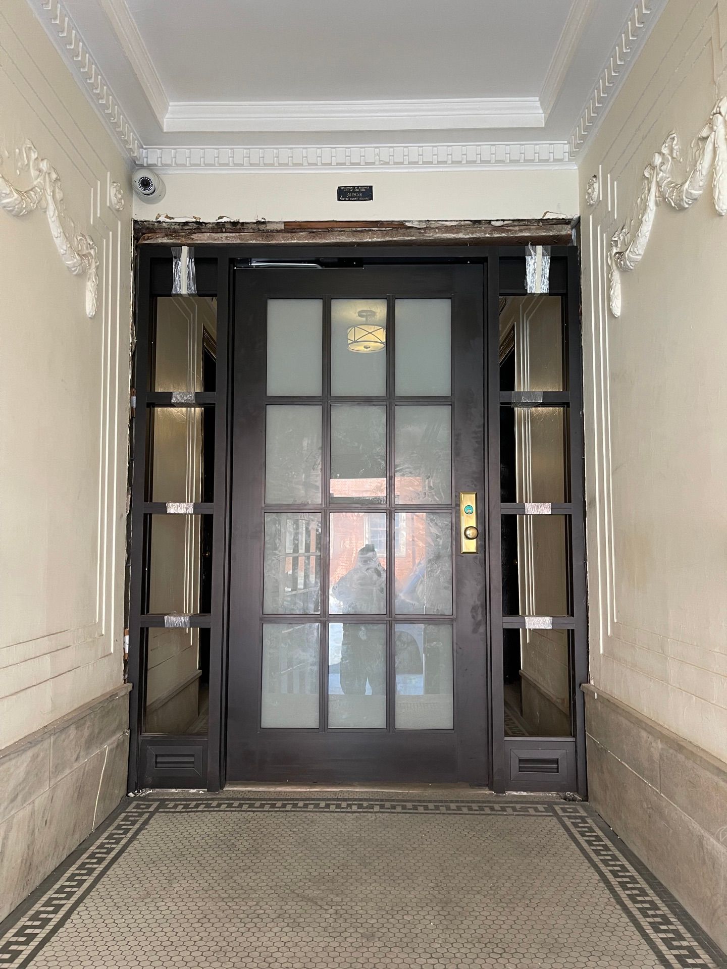 Installing new vestibule door at an apartment building in Long Island City, Queens 