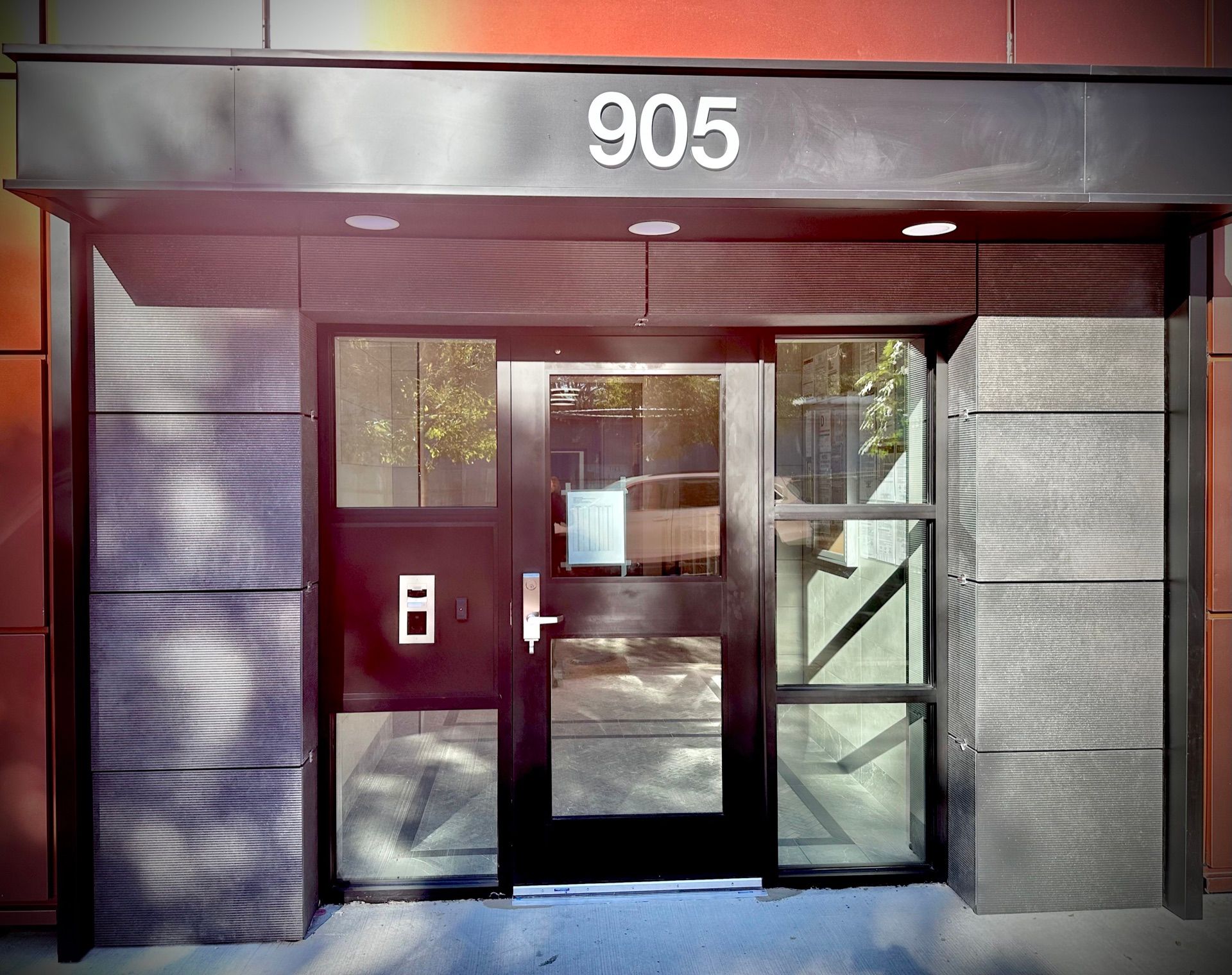 Exterior view of new storefront door system installed at apartment building in The Bronx