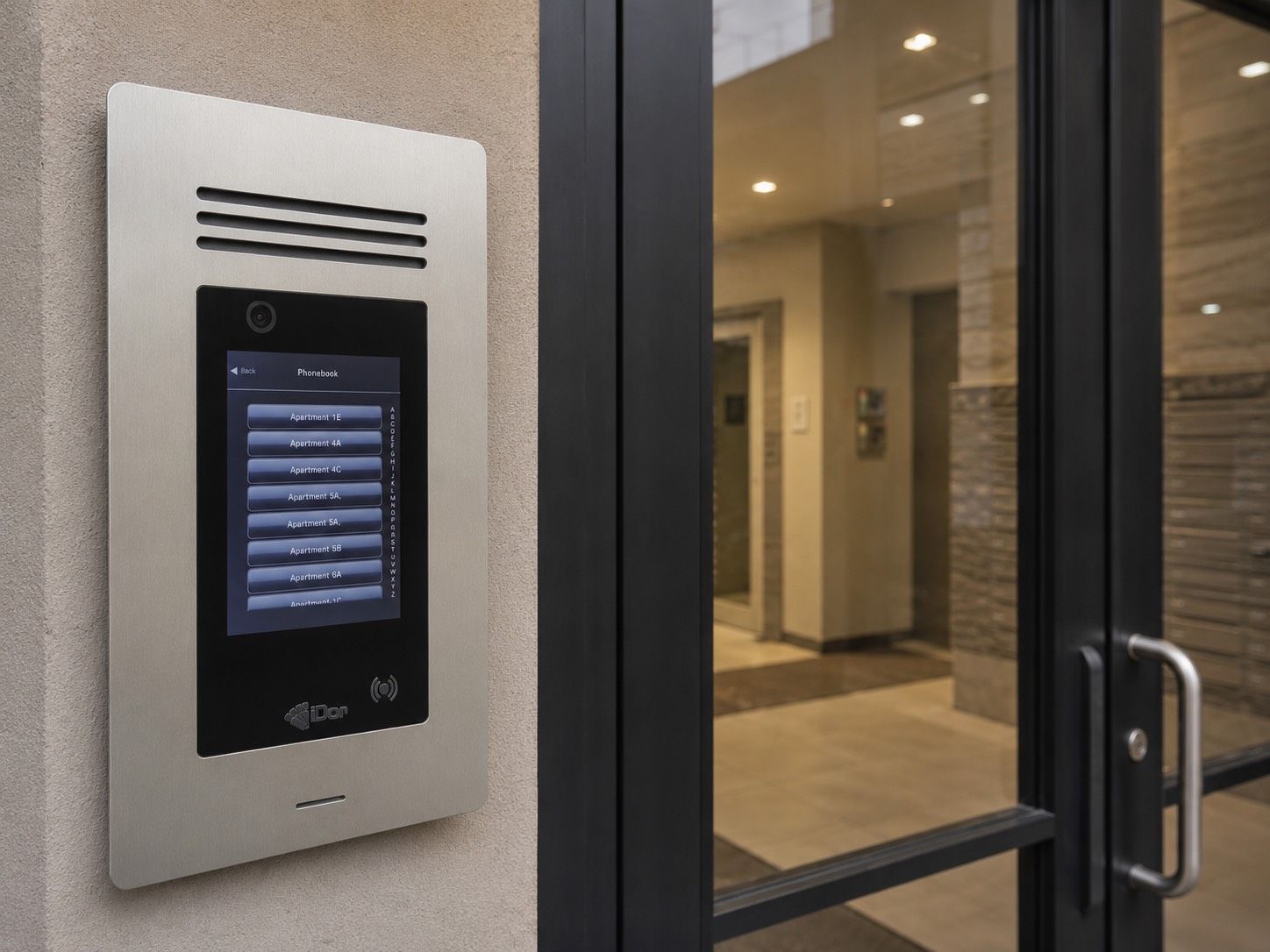 Video door-entry intercom panel with a resident directory at the entrance of a multi-tenant apartment building