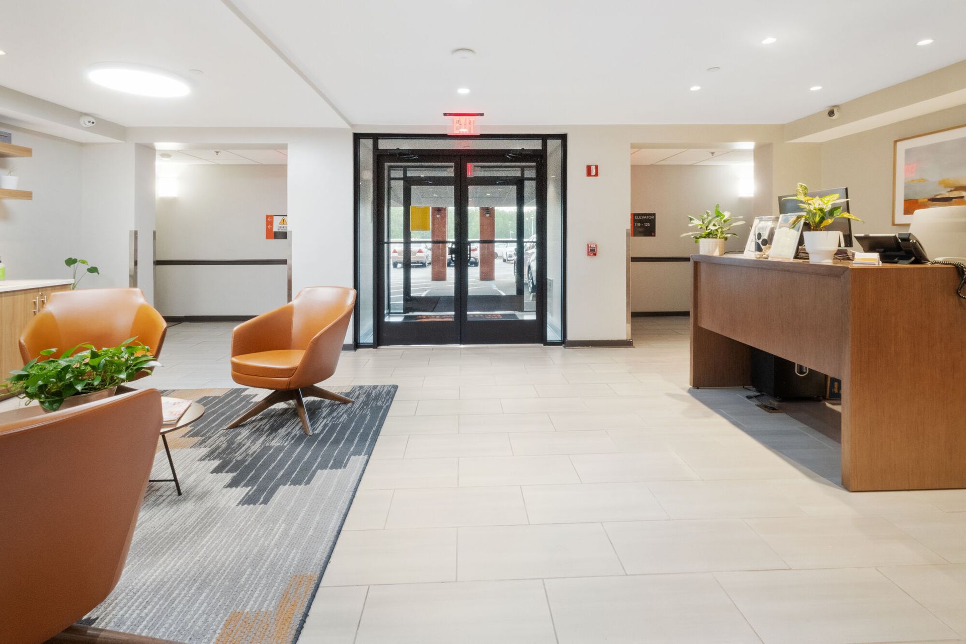 Modern lobby with seating, reception desk, and entrance doors. Our pet-friendly apartments in New Brunswick, NJ offer convenient amenities, like a clubhouse, fitness center, and package lockers. Visit us today for a tour!