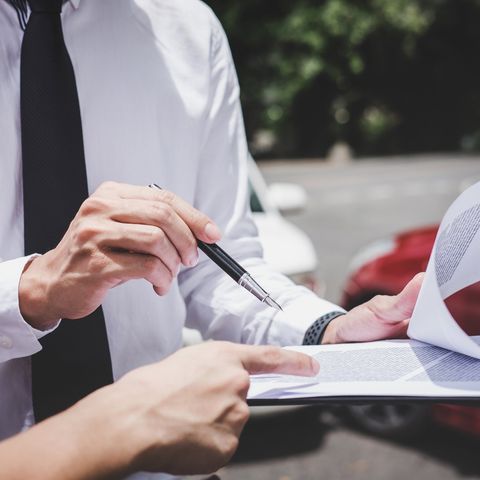Car — Insurance Agent Working on Report Form in Bridgeton, NJ