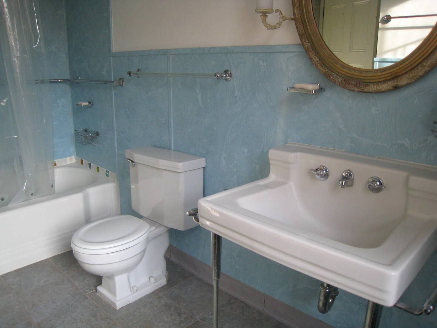 A bathroom with a toilet , sink and bathtub