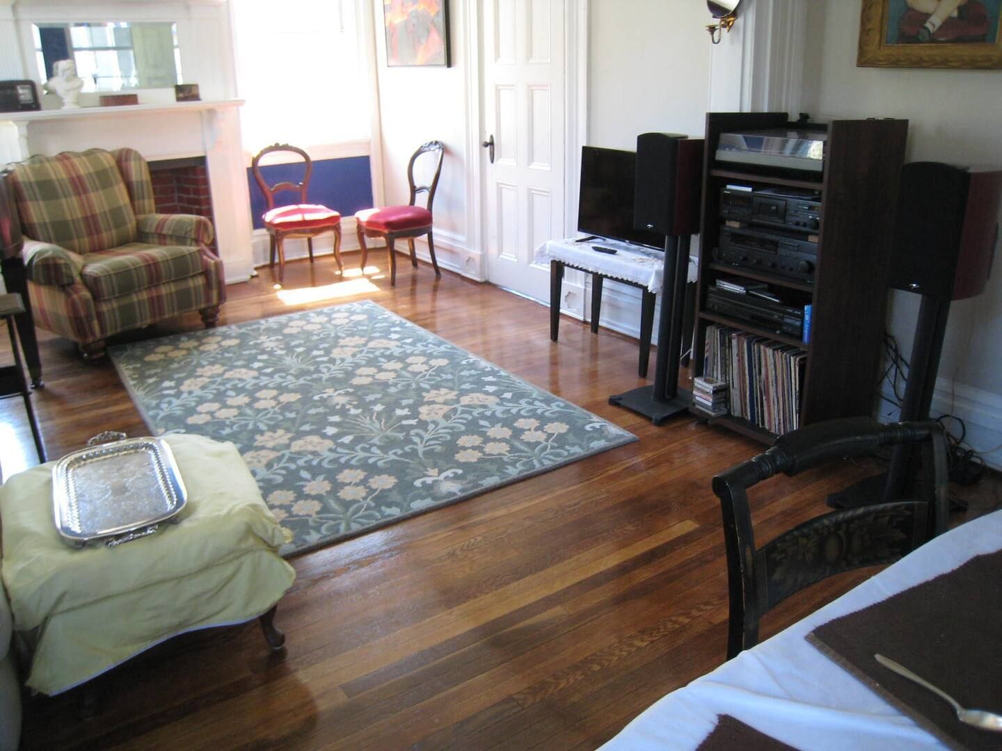 A living room with hardwood floors and a rug