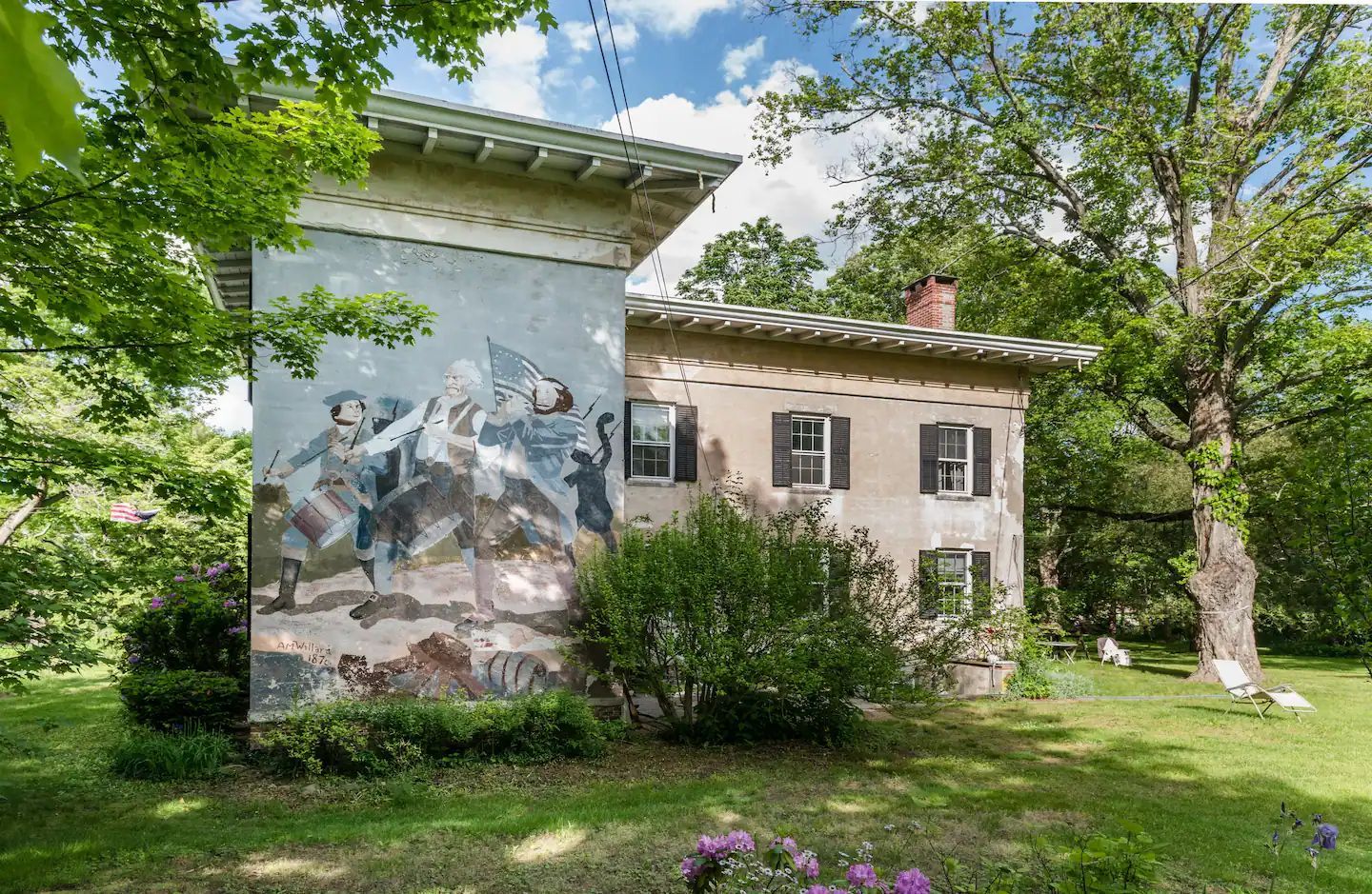 A house with a large mural on the side of it.