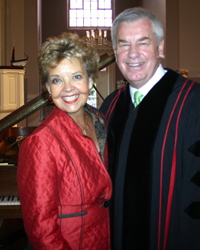 A man and a woman are posing for a picture in a church