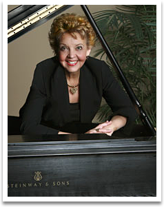 A woman is sitting at a steinway & sons piano