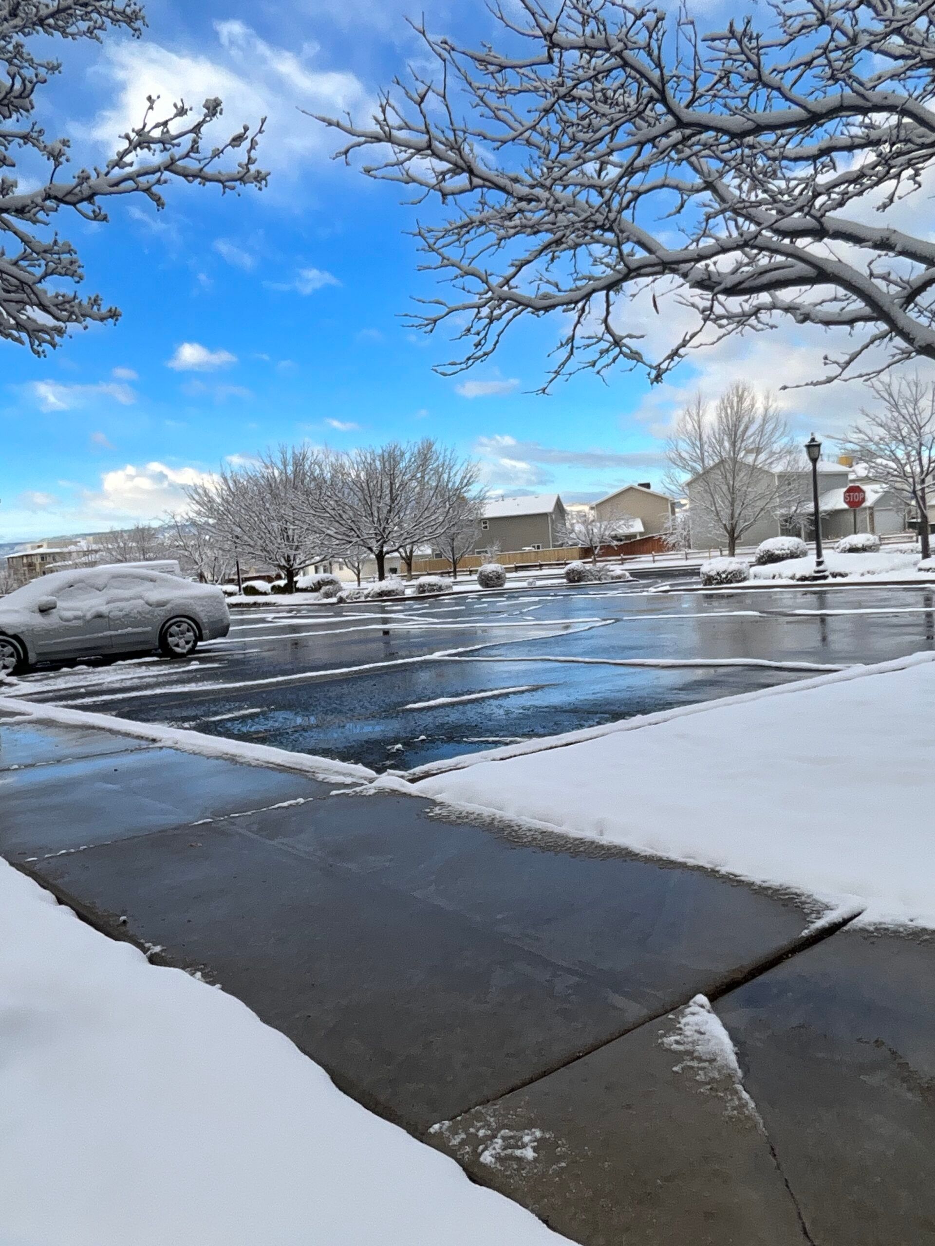 A car is parked in a snowy parking lot