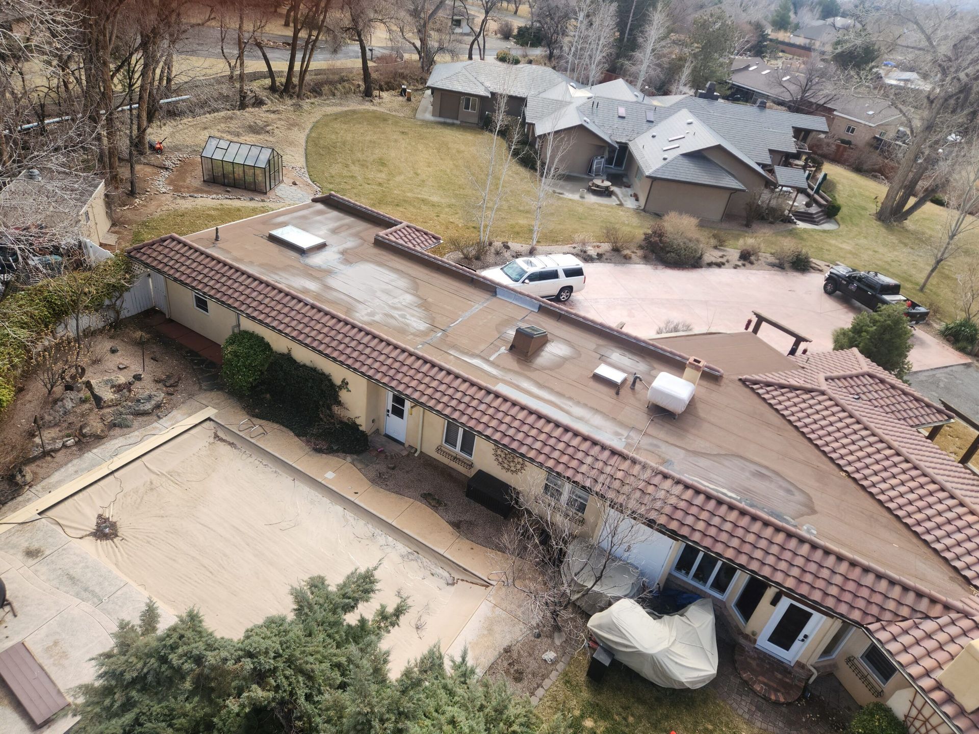 An aerial view of a house with a swimming pool