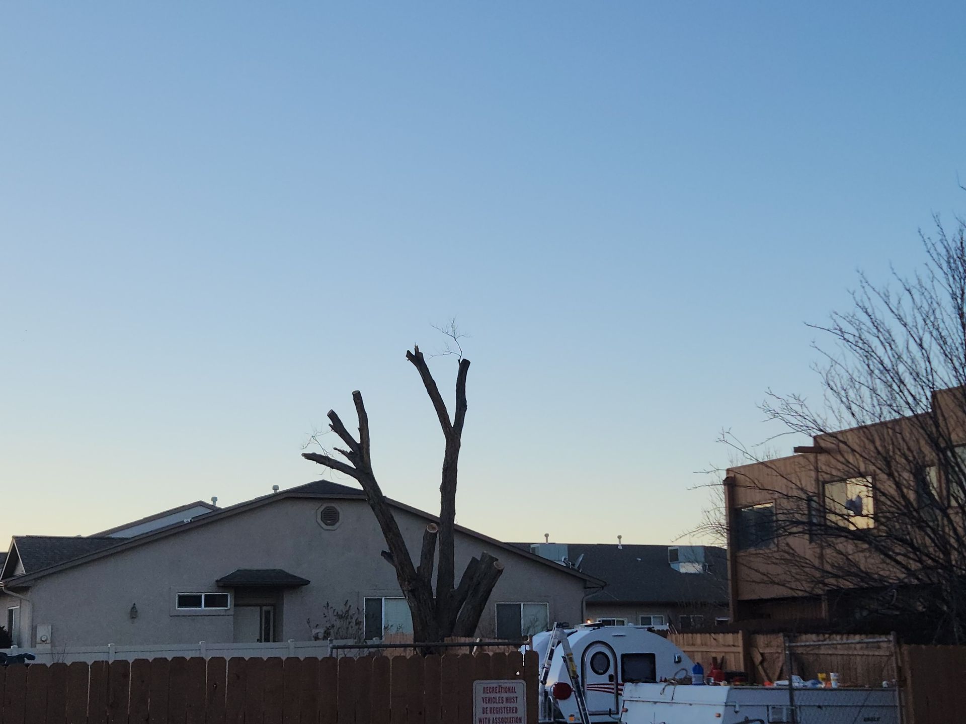 A rv is parked in front of a house